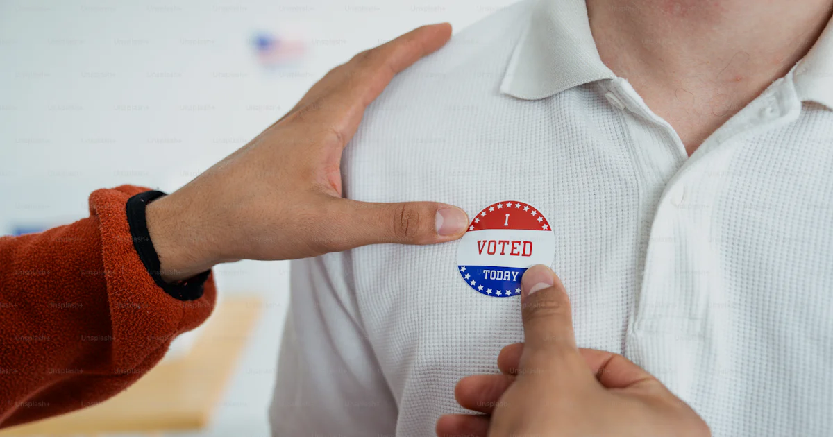 Man Putting Sticker A person putting a sticker on another person's shirt photo – Vote Image ...