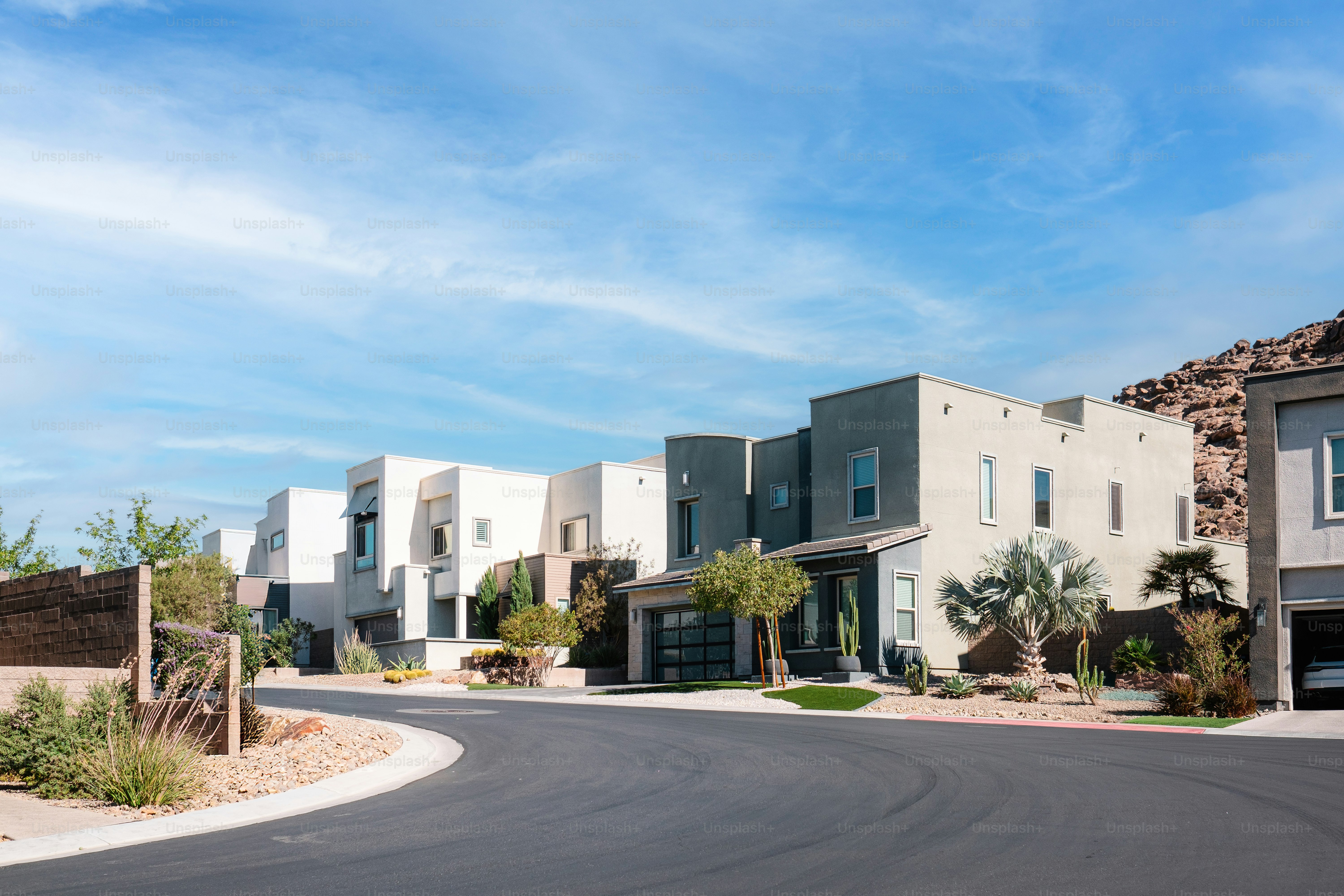 A street lined with houses and palm trees