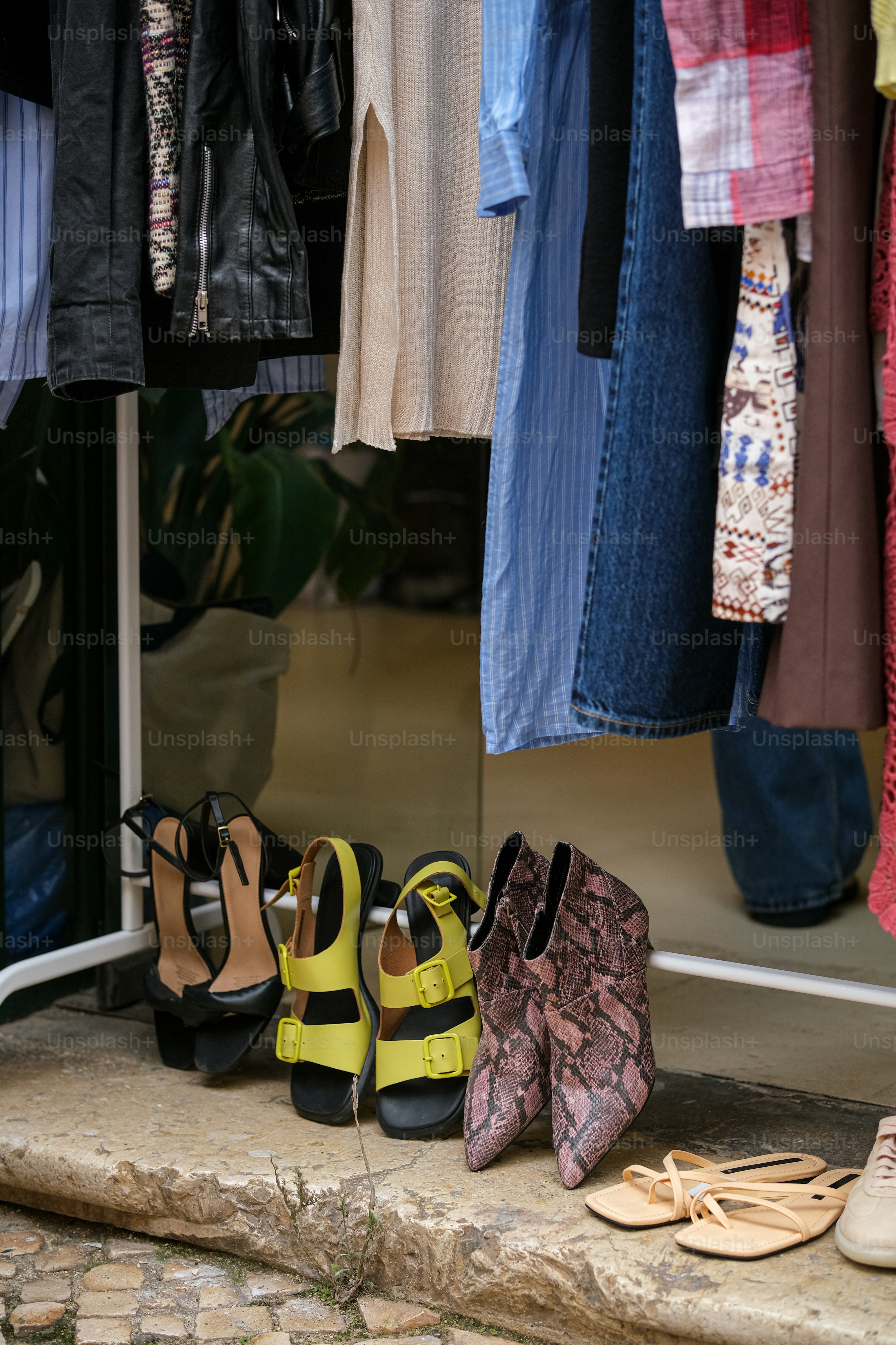 A bunch of shoes that are on a ledge