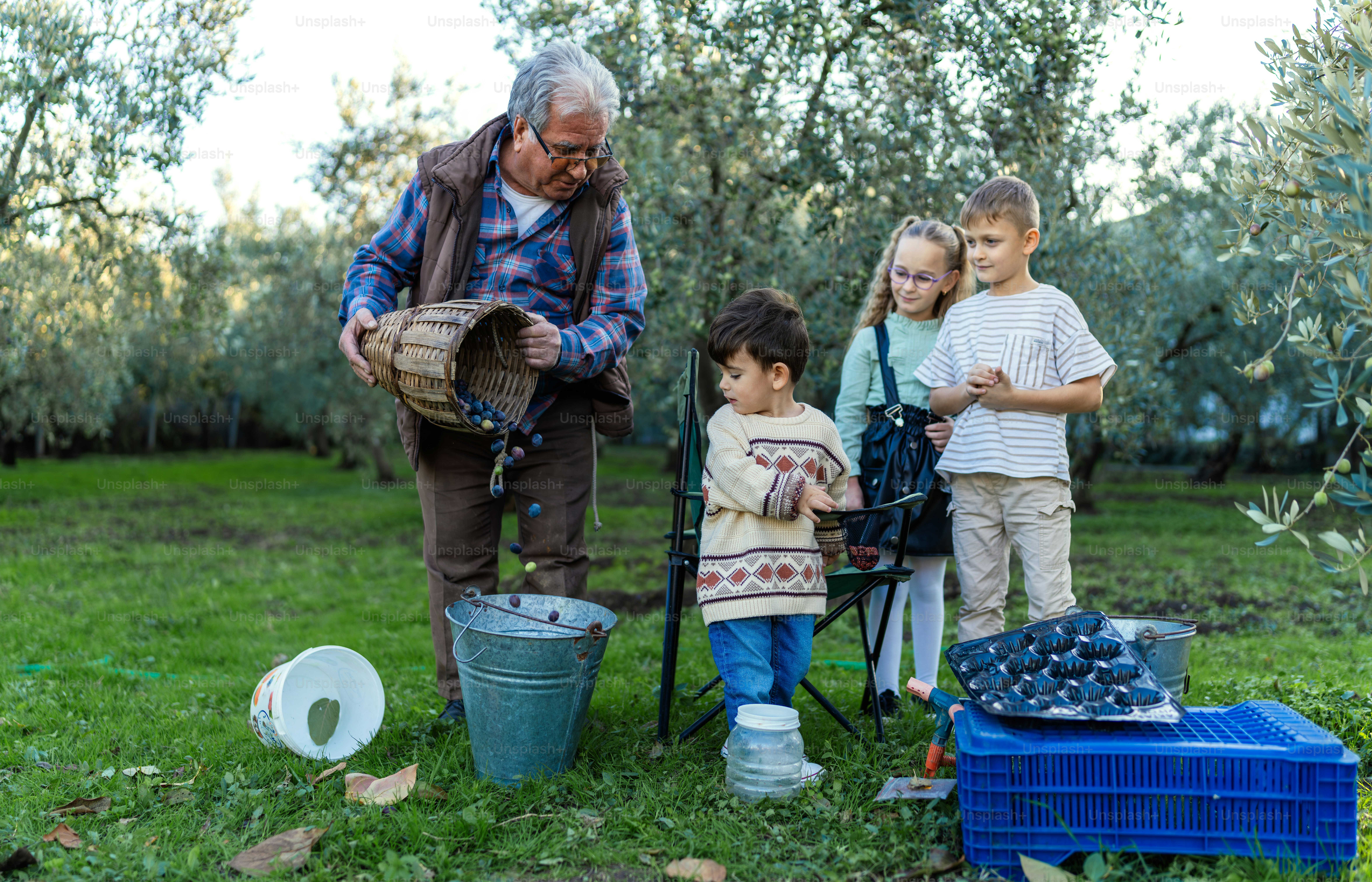 A man standing next to two children in a field