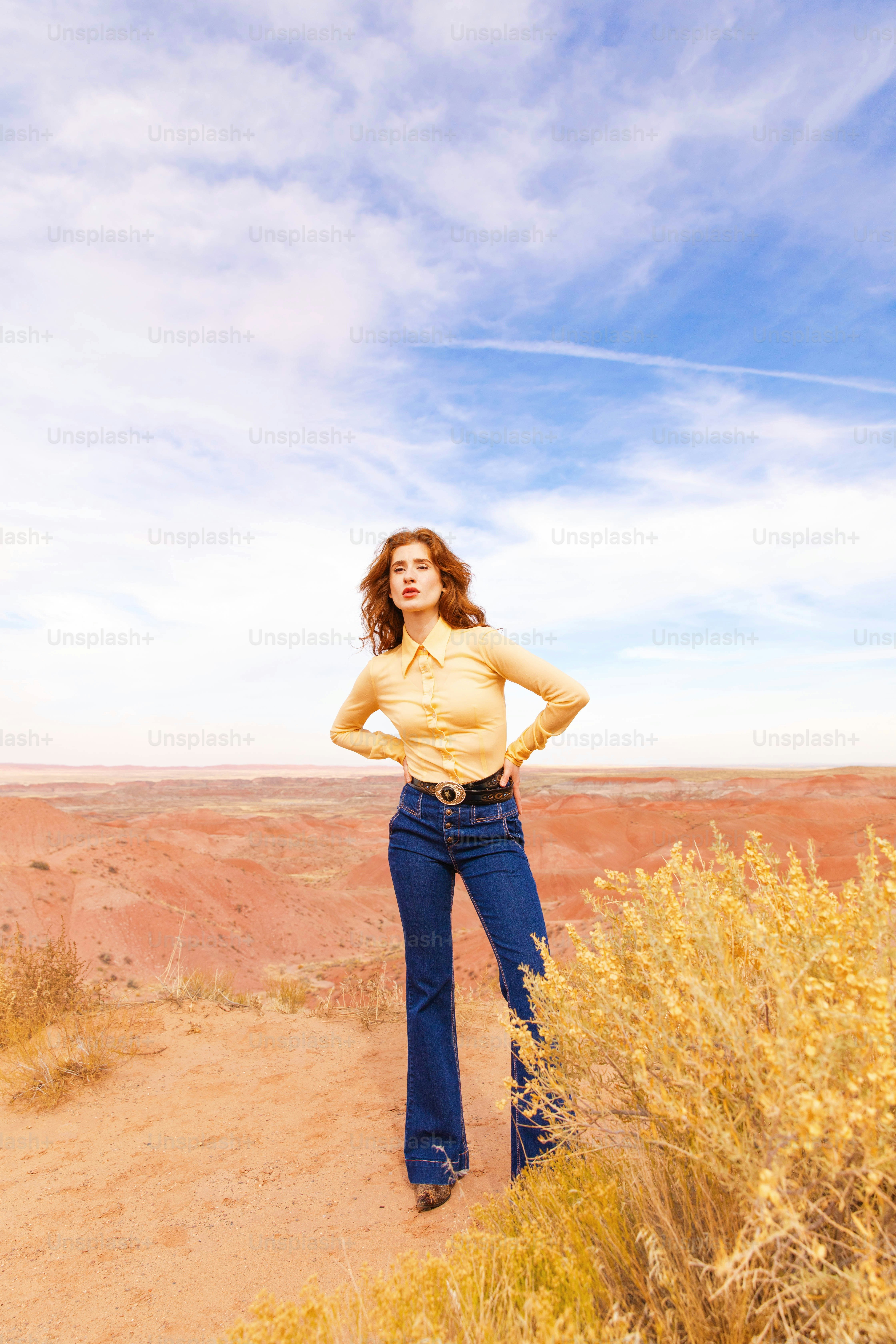 A woman standing in the desert with her hands on her hips