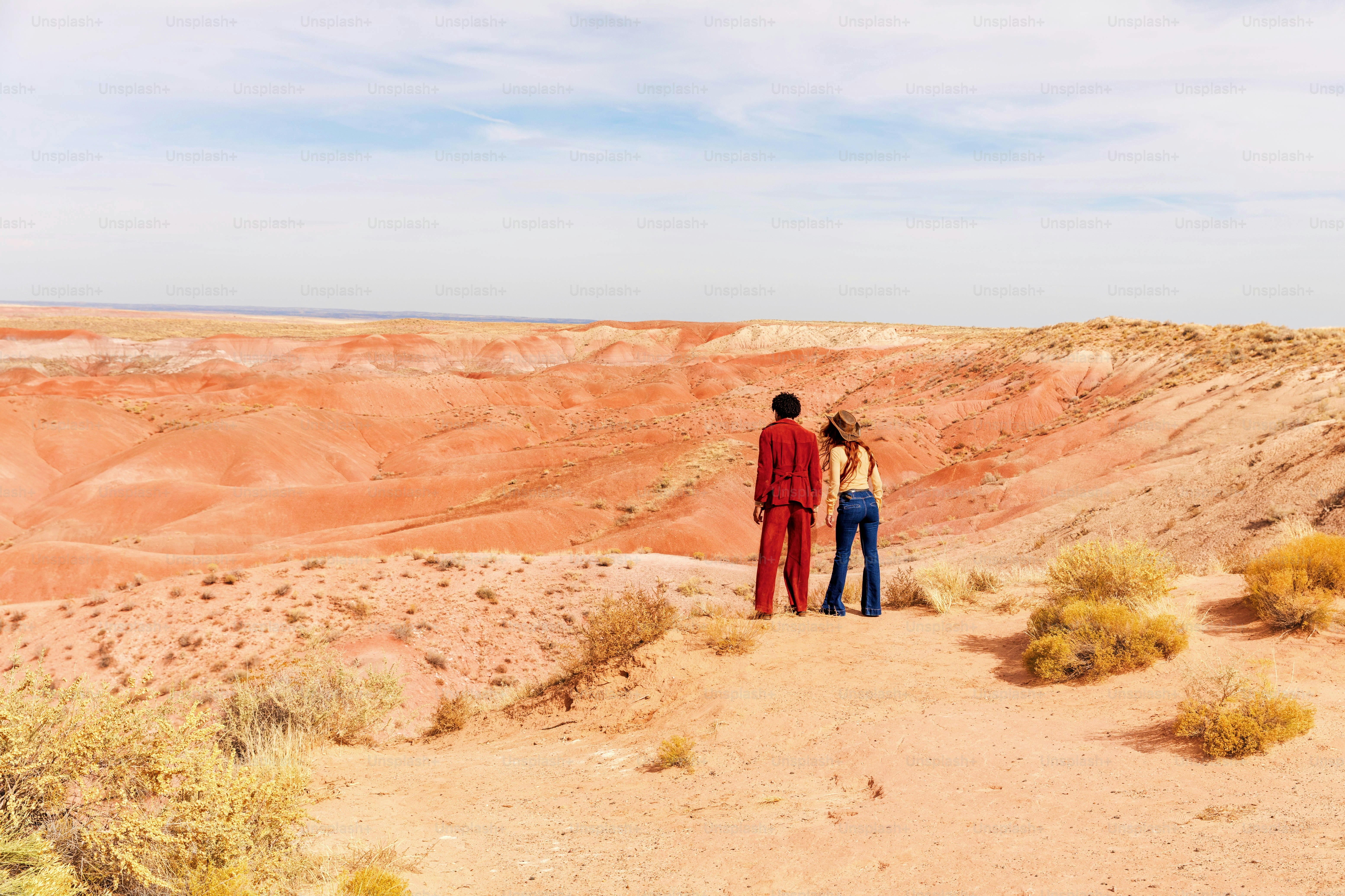 A woman in a blue dress and pink cowboy boots photo – Desert Image on ...