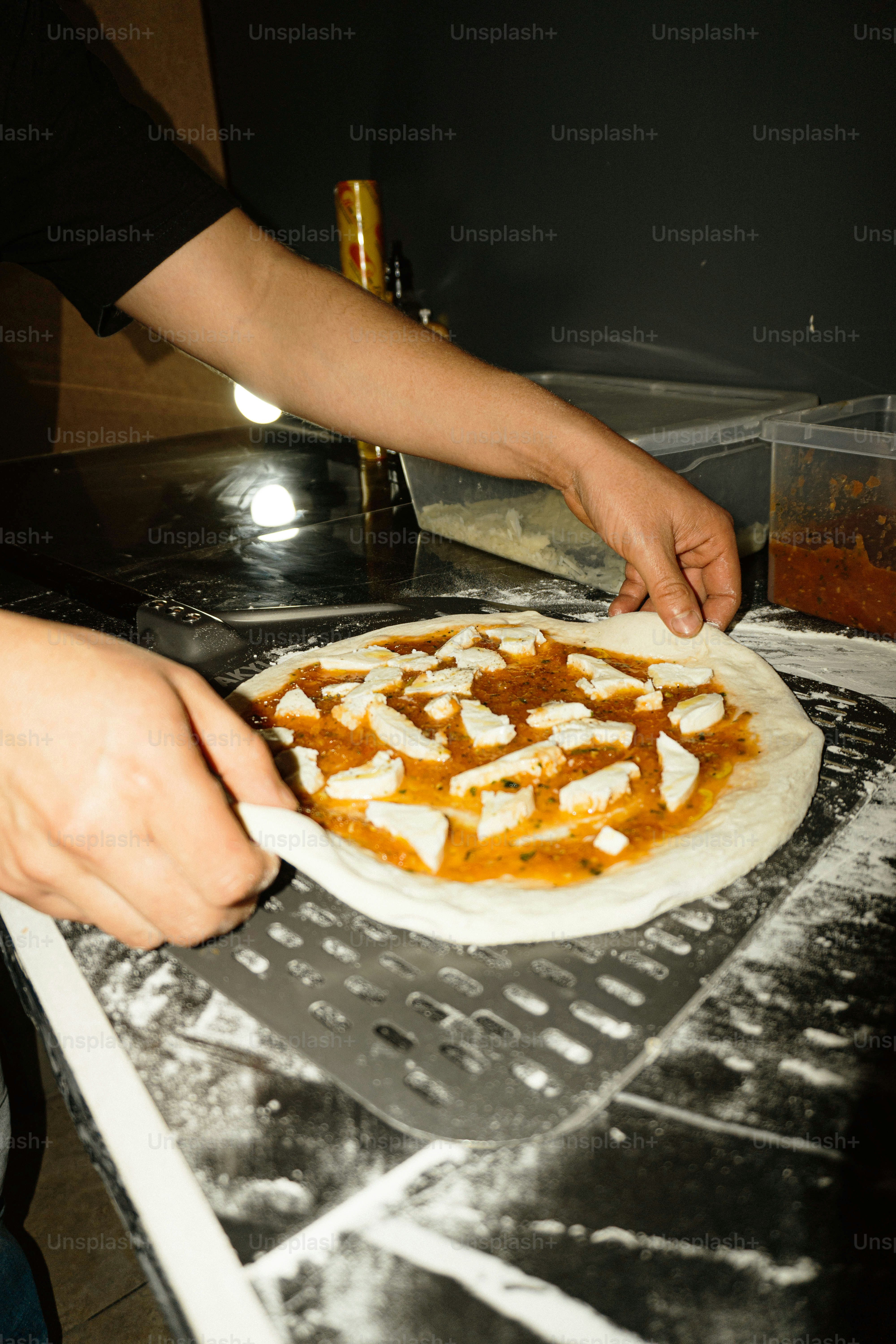A person wiping up a counter top with a rag photo – Pizza Image on Unsplash