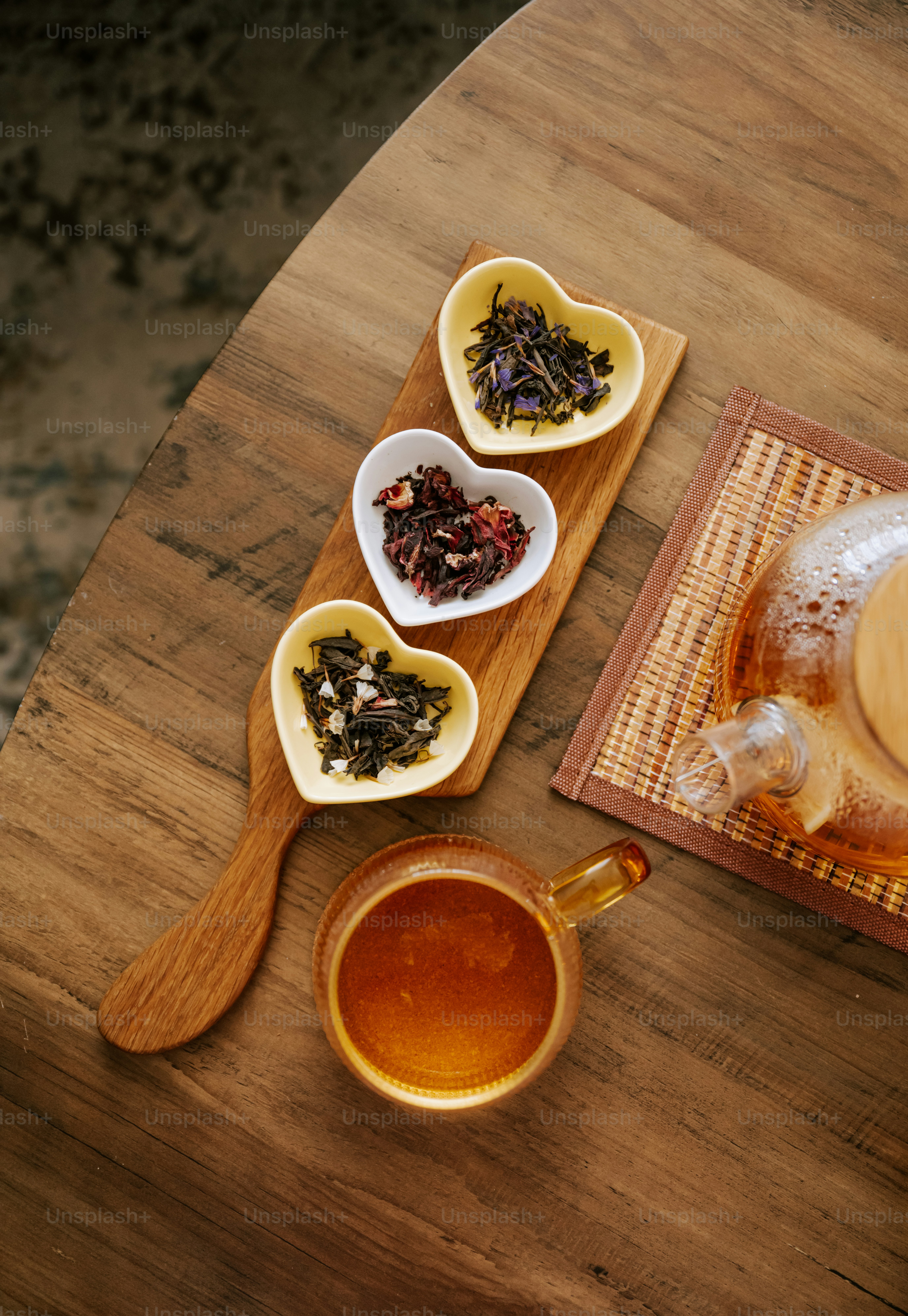 A wooden table topped with bowls of food