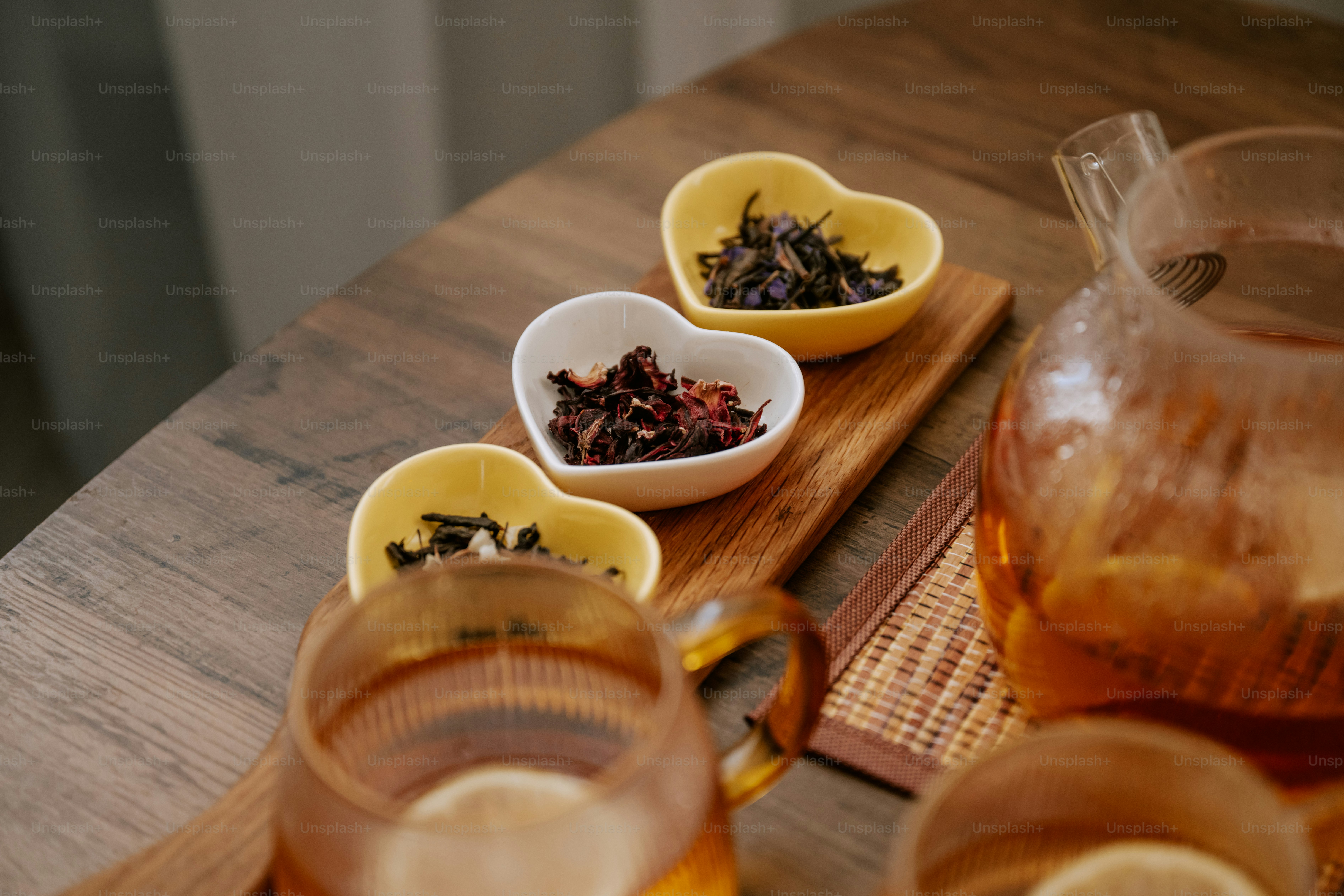 A wooden table topped with lots of different types of tea photo – Tea ...