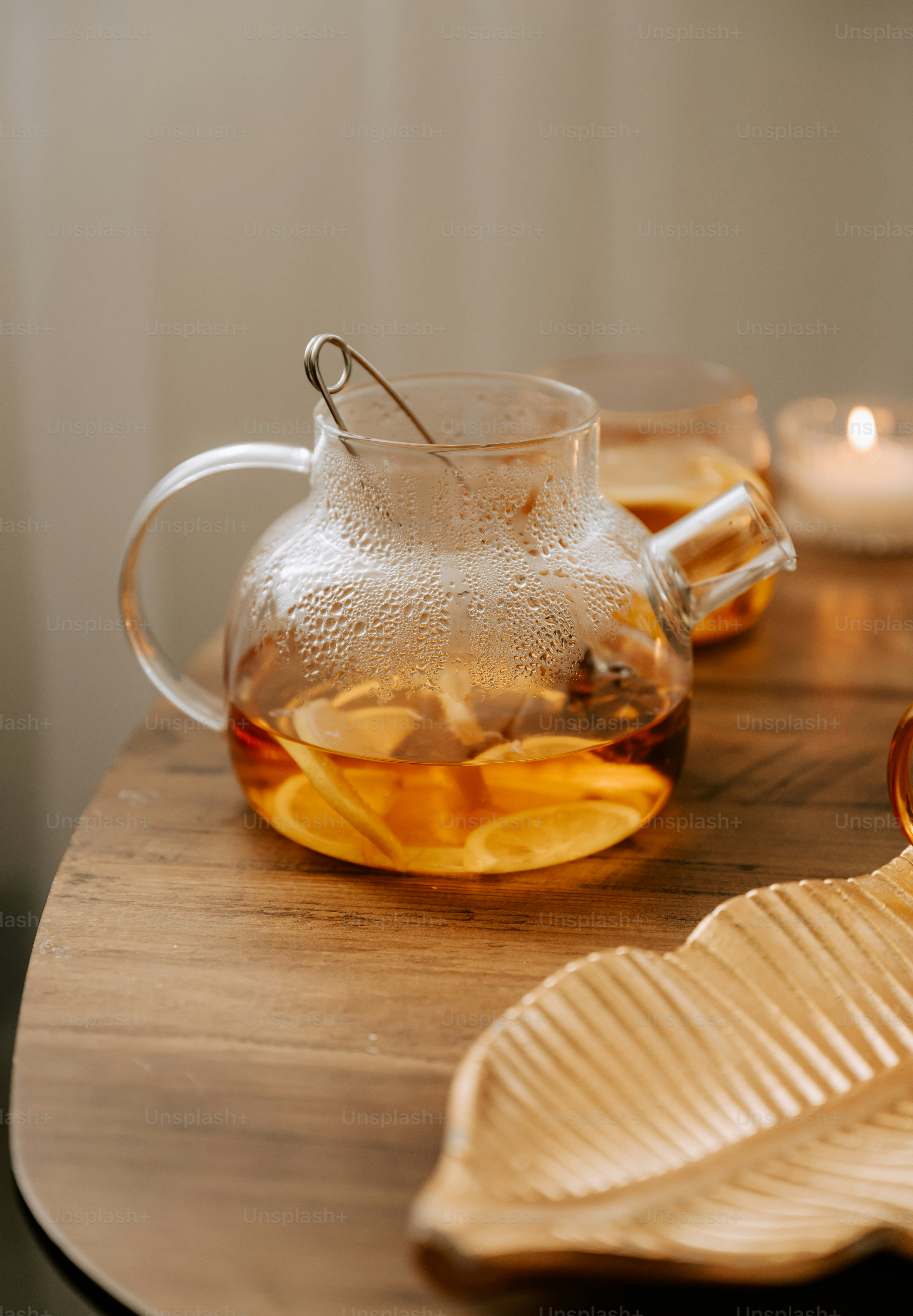 A wooden table topped with a tea pot filled with tea photo – Tea Image ...