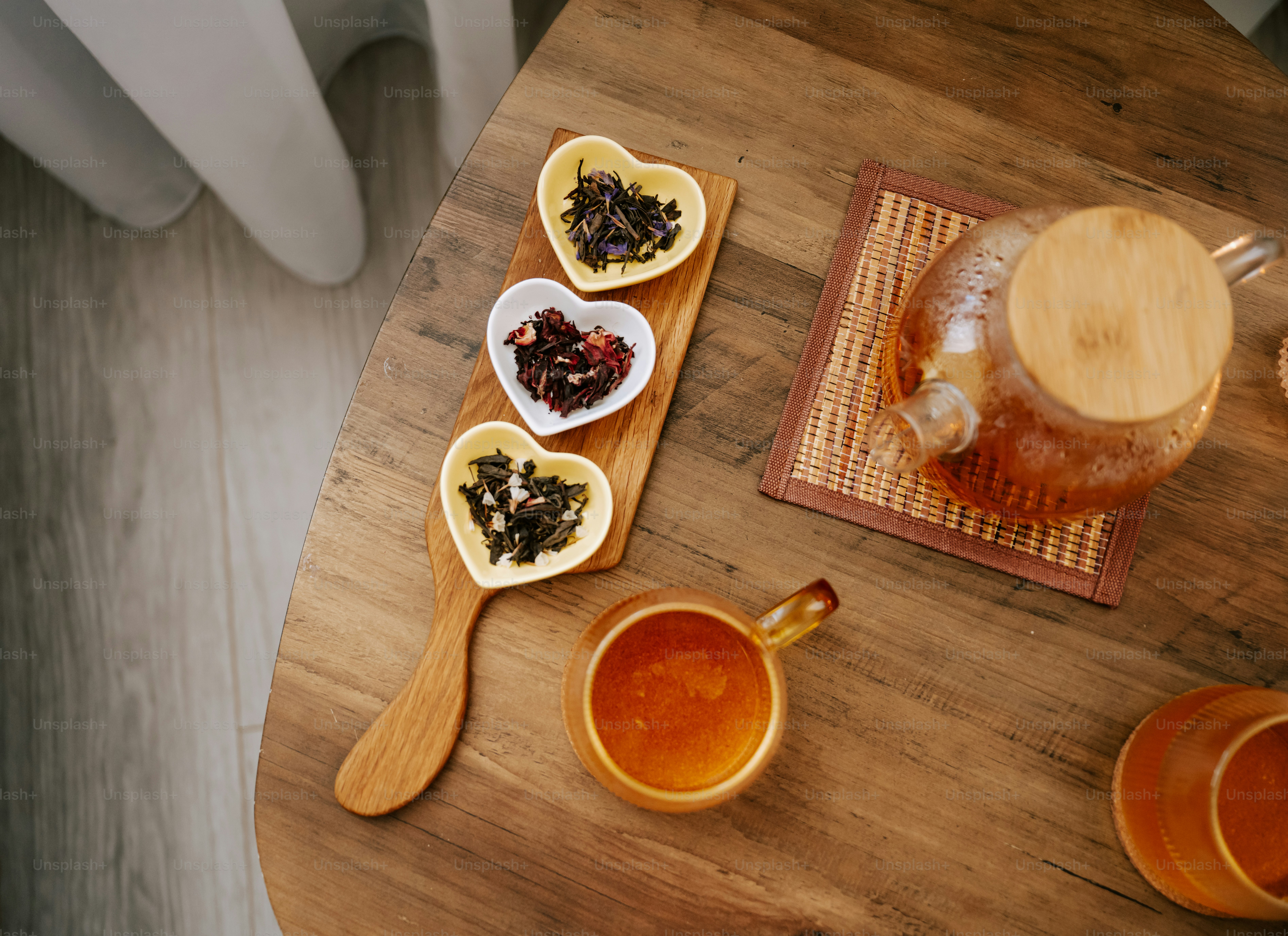 A wooden table topped with lots of different types of tea photo – Tea ...