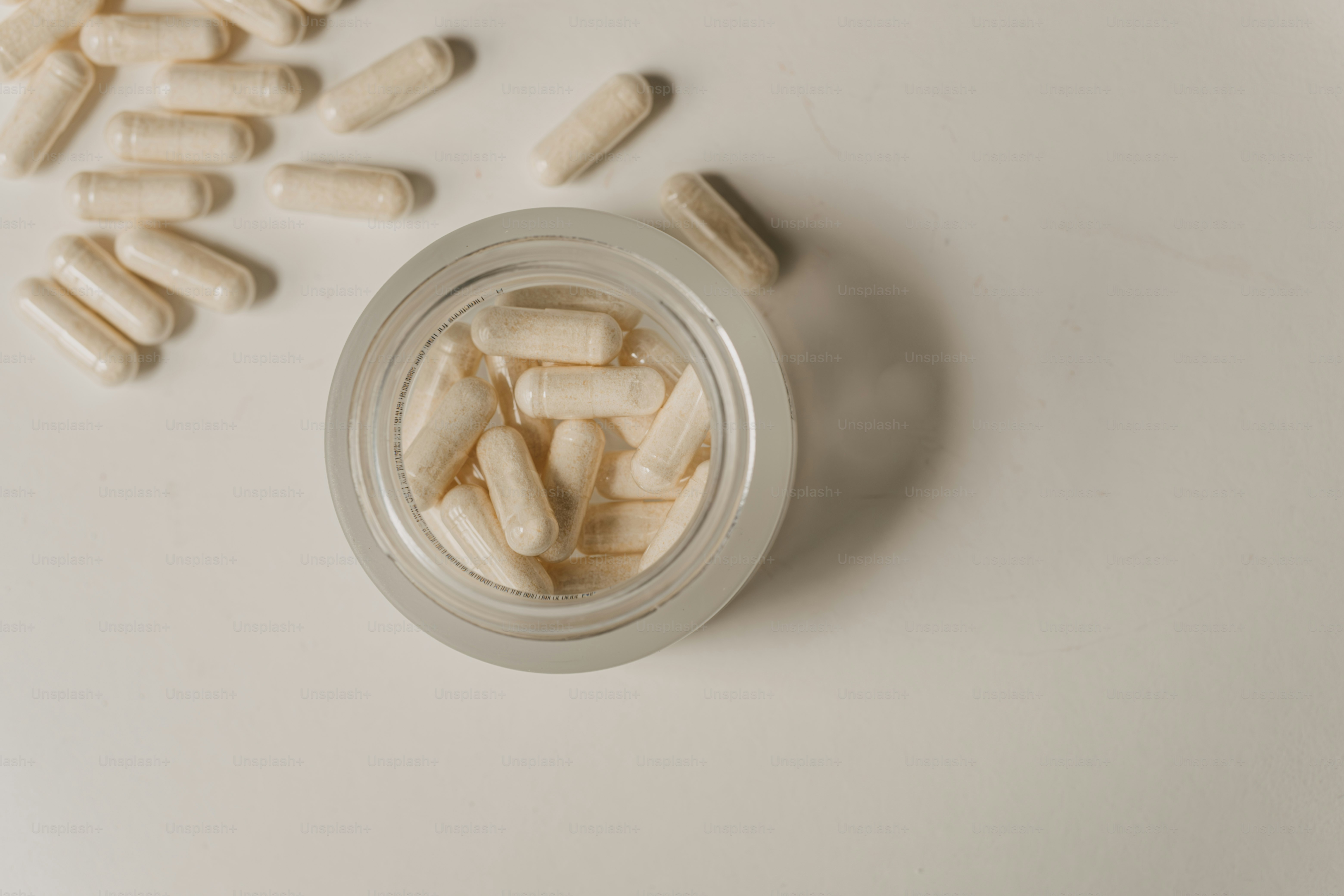 A group of pills sitting on top of a table photo – Wellness Image on ...