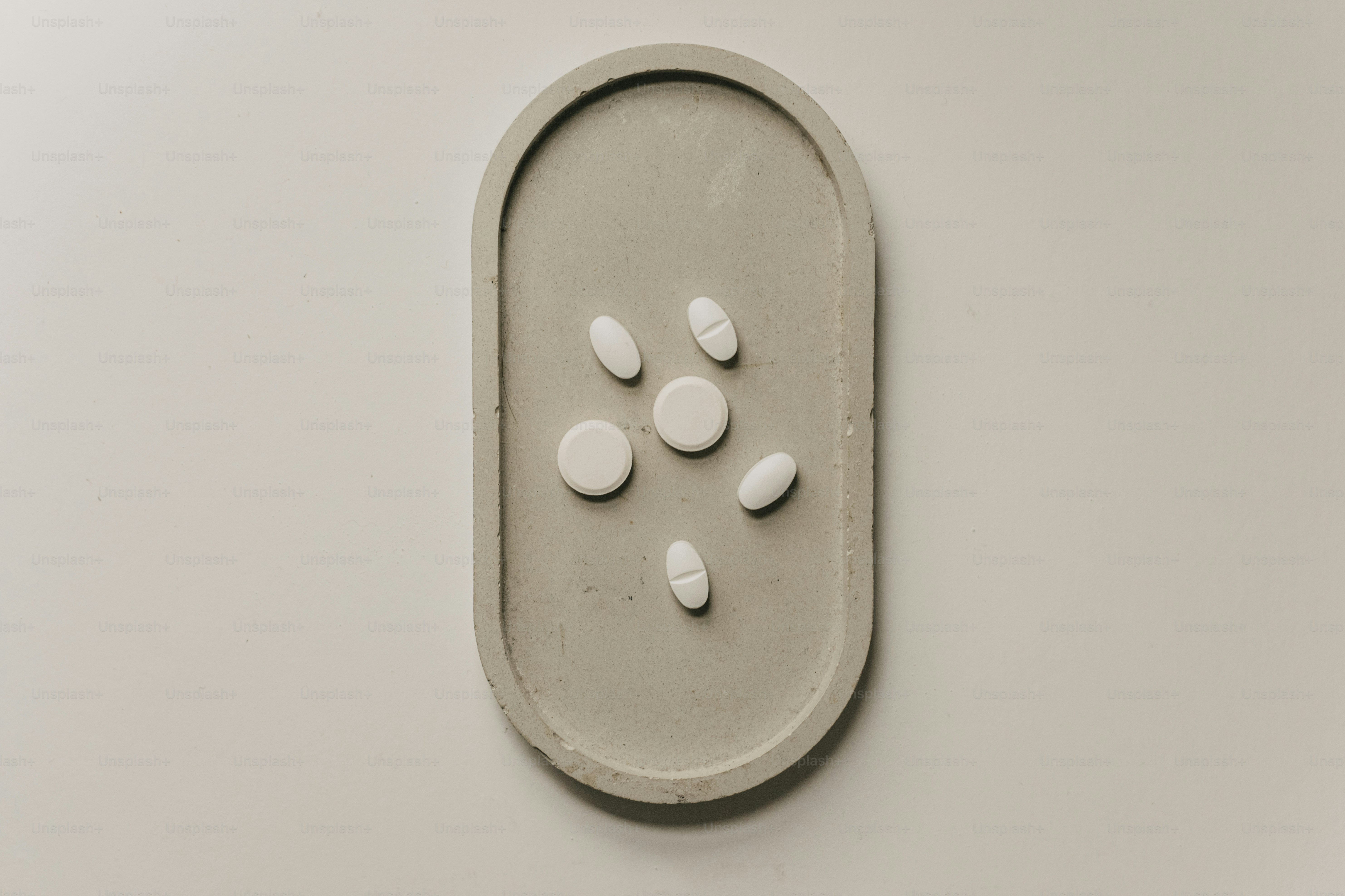 A group of pills sitting on top of a white wall