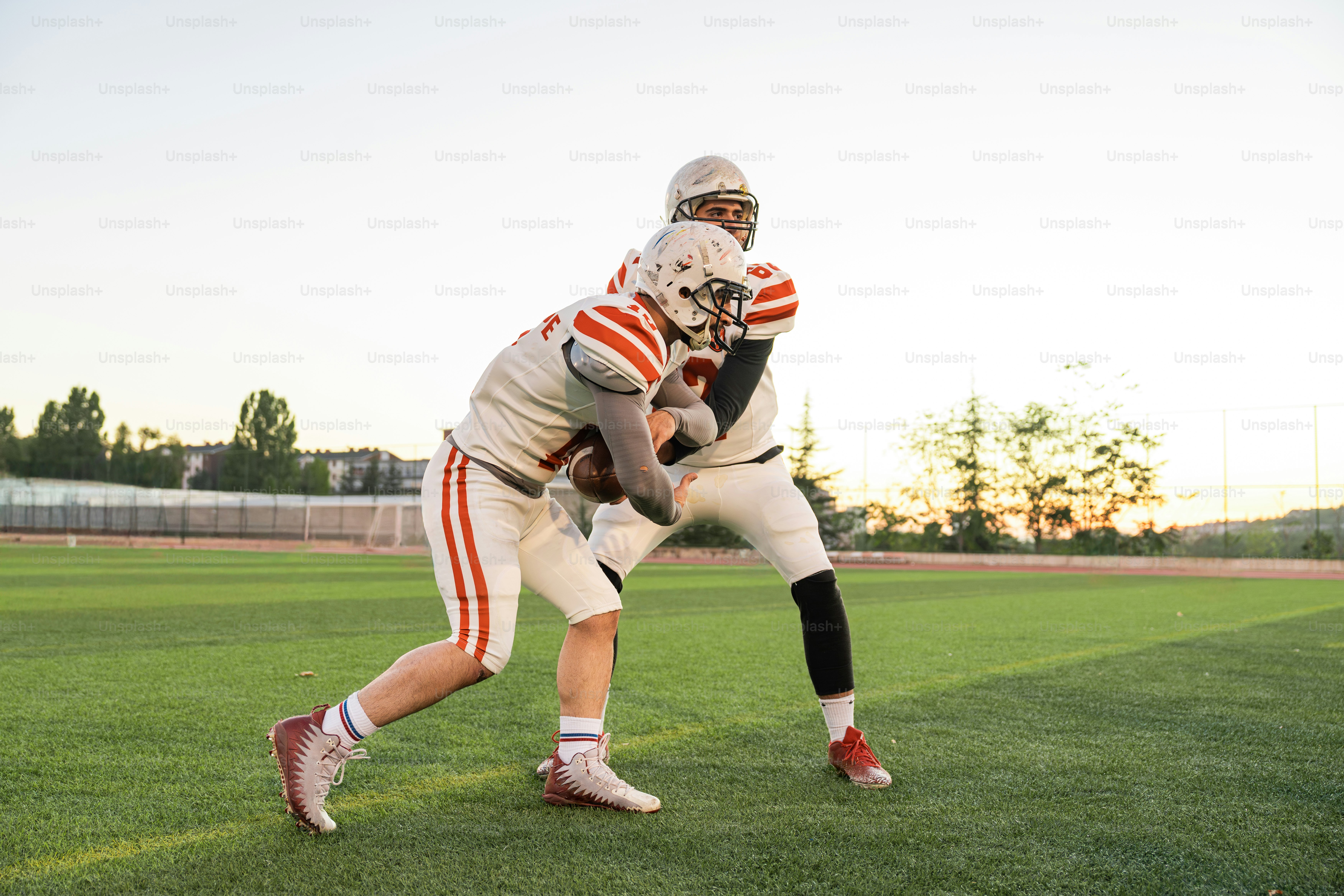 A football player holding a ball on a field