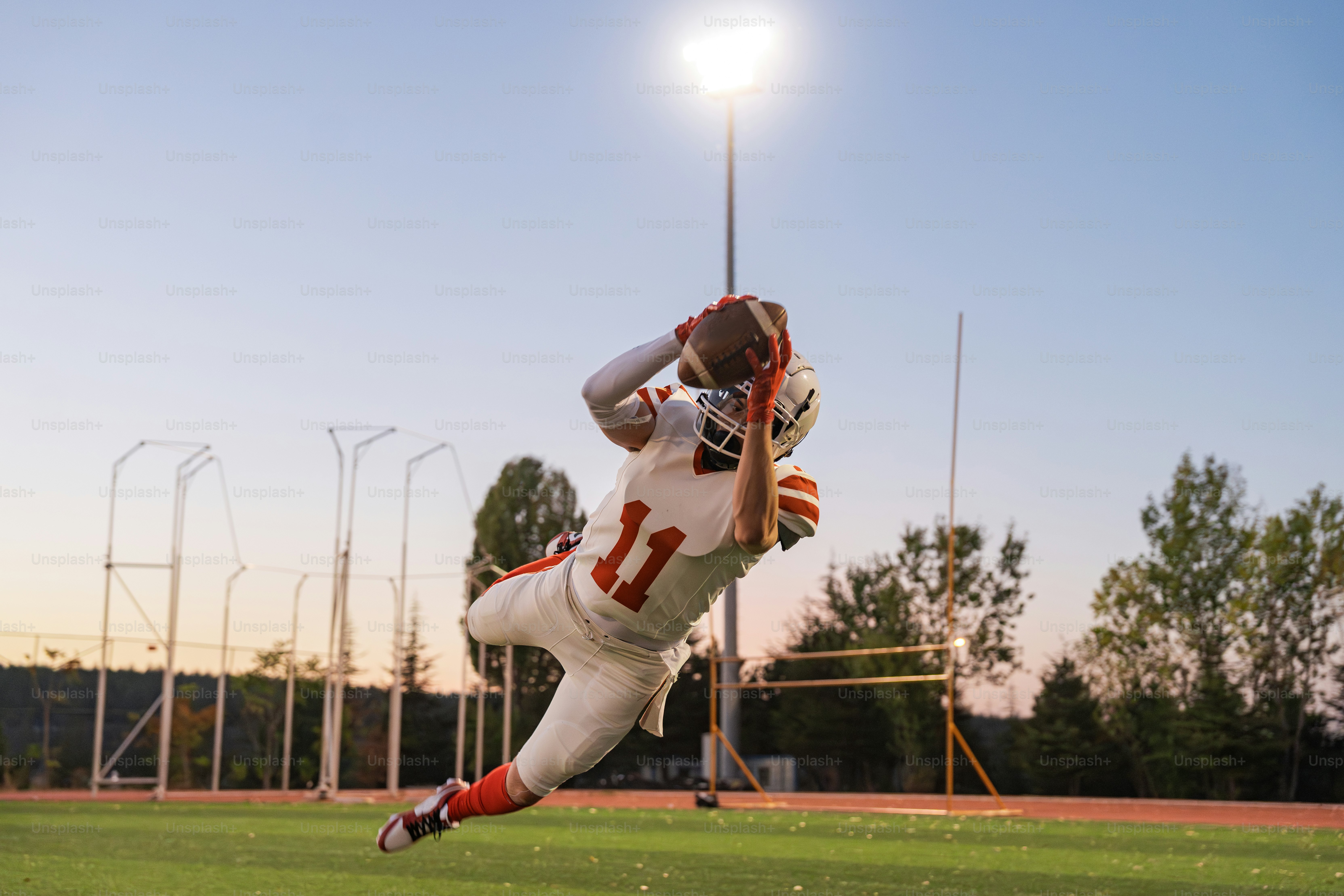 A football player catching a ball on a field