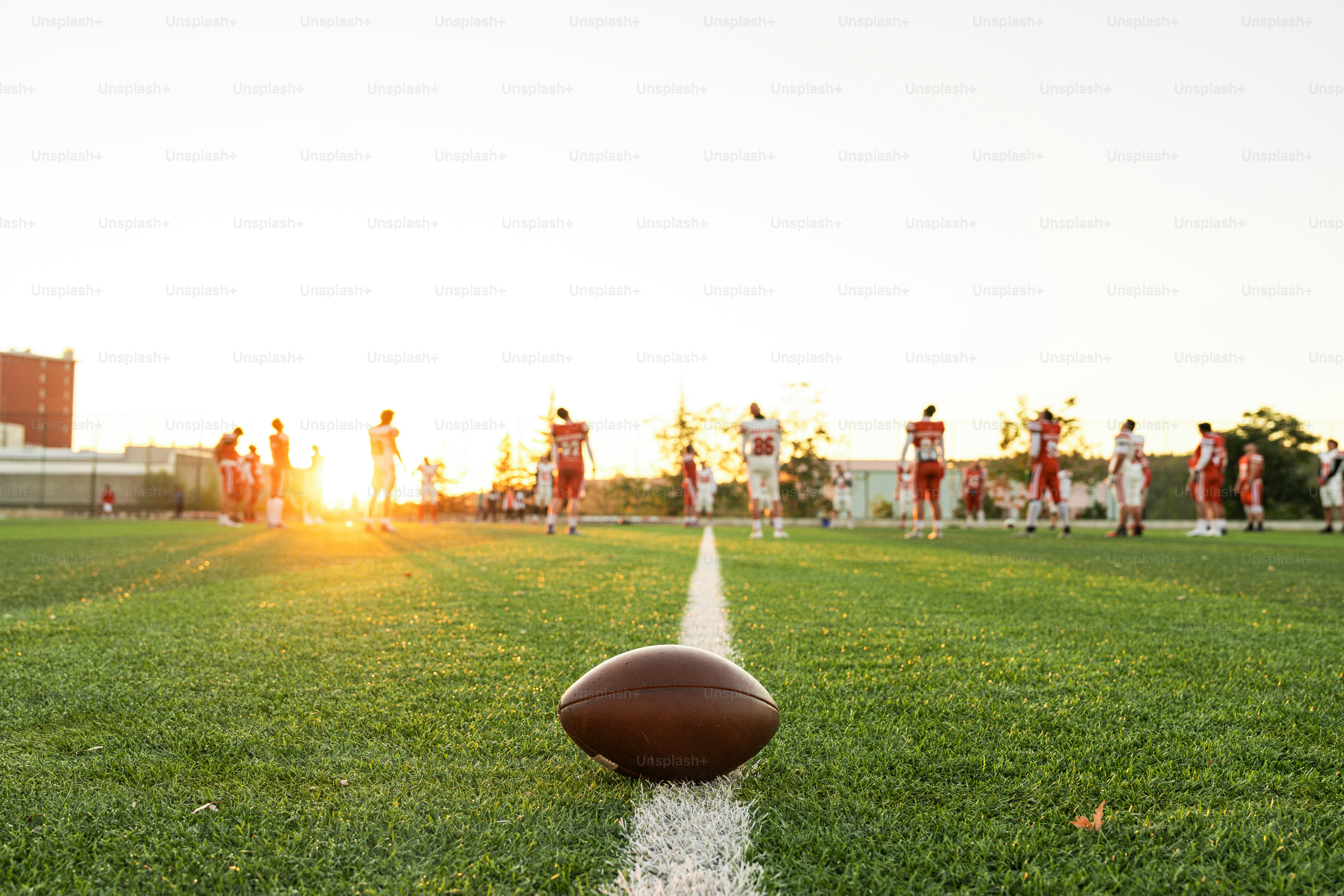 A football sitting on top of a lush green field