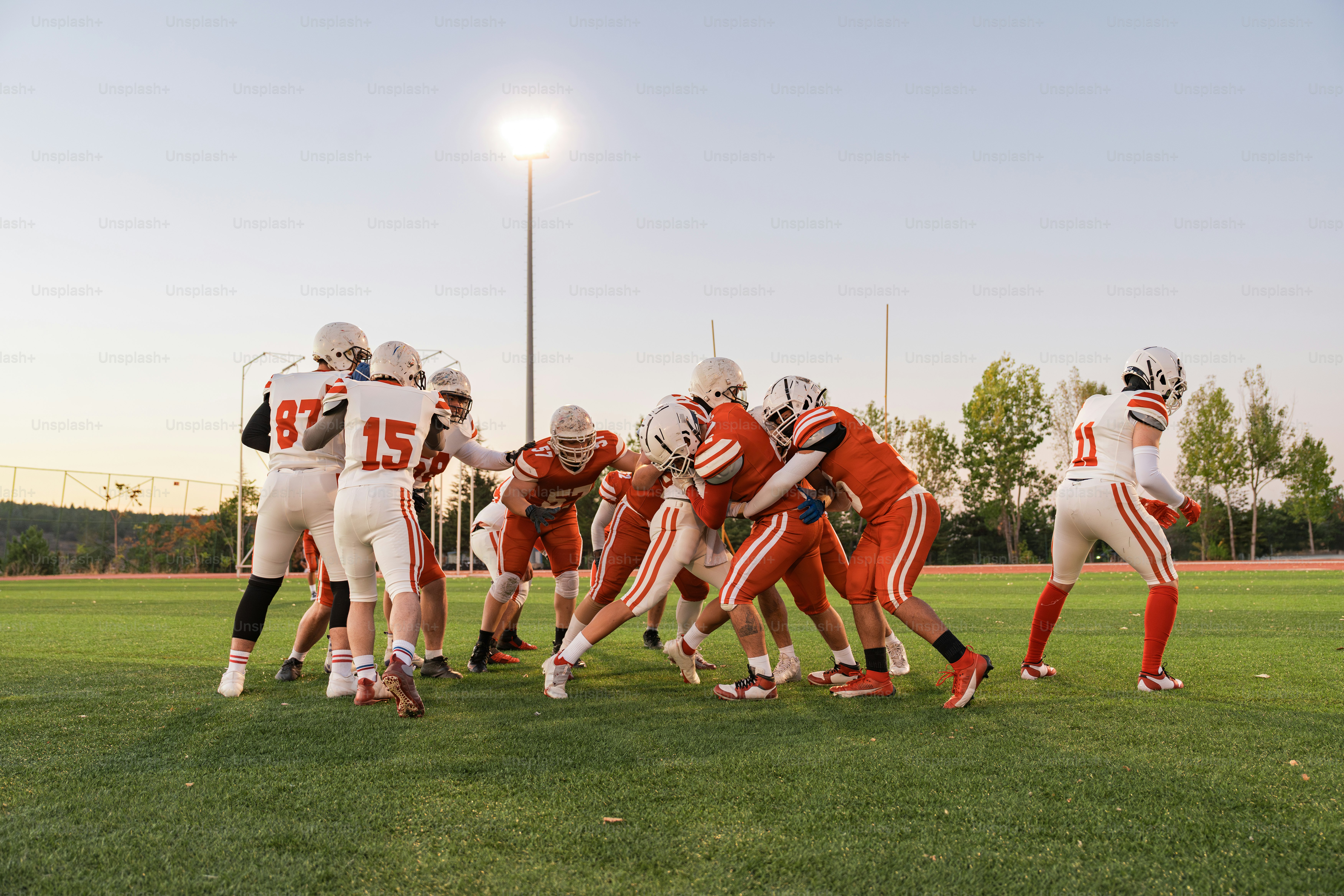 A group of football players standing on top of a field