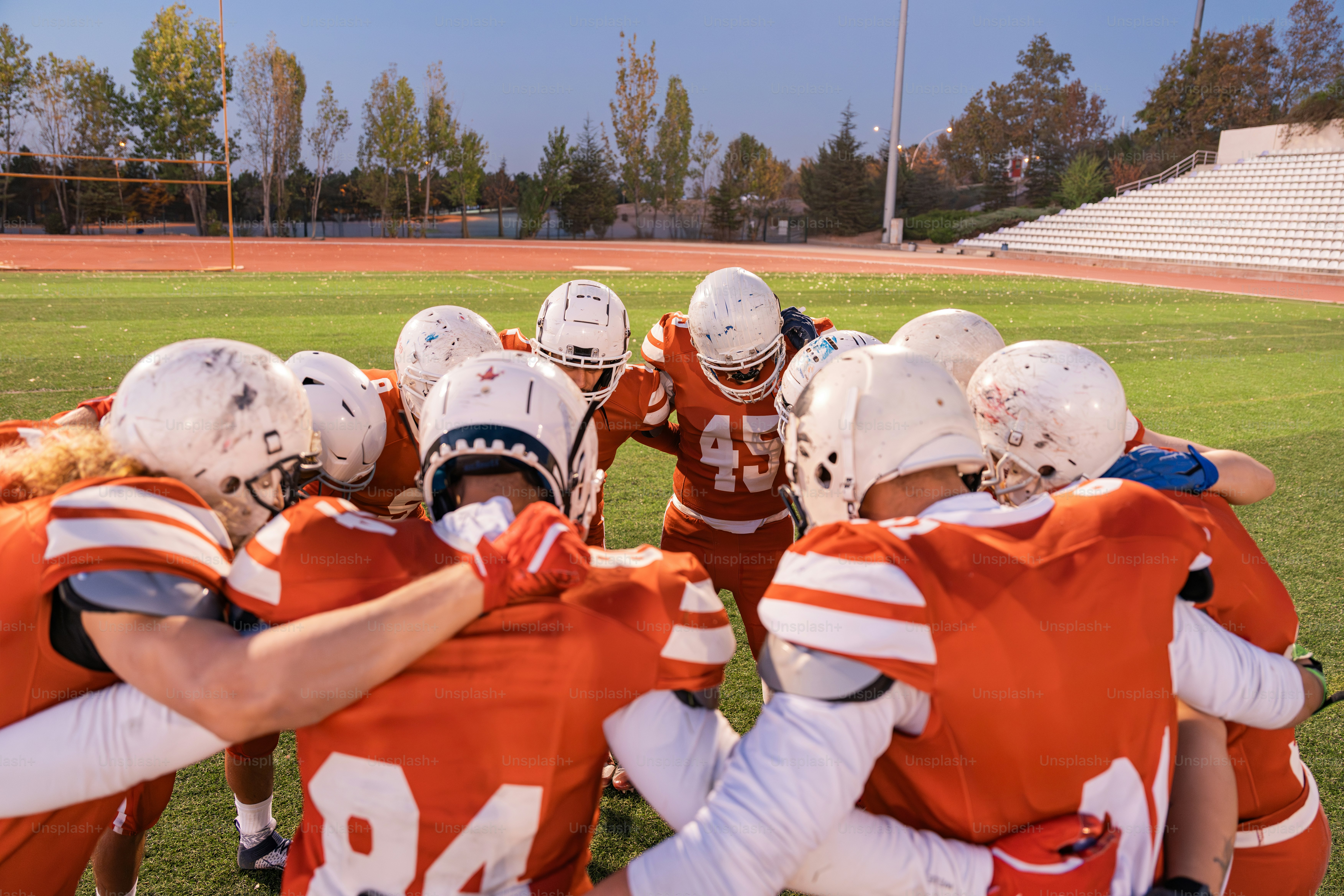 A group of football players standing on top of a field
