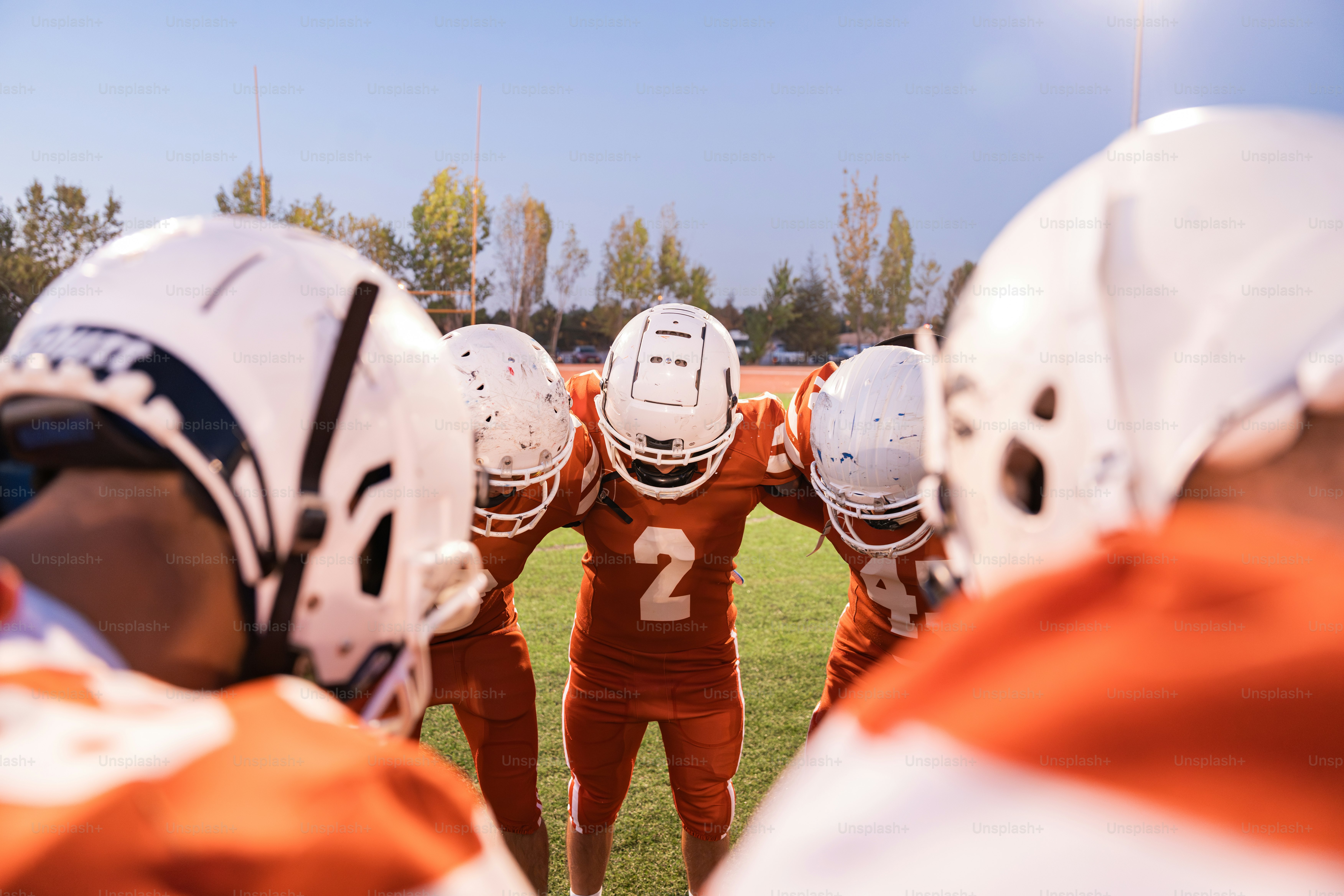 A group of football players standing on top of a field
