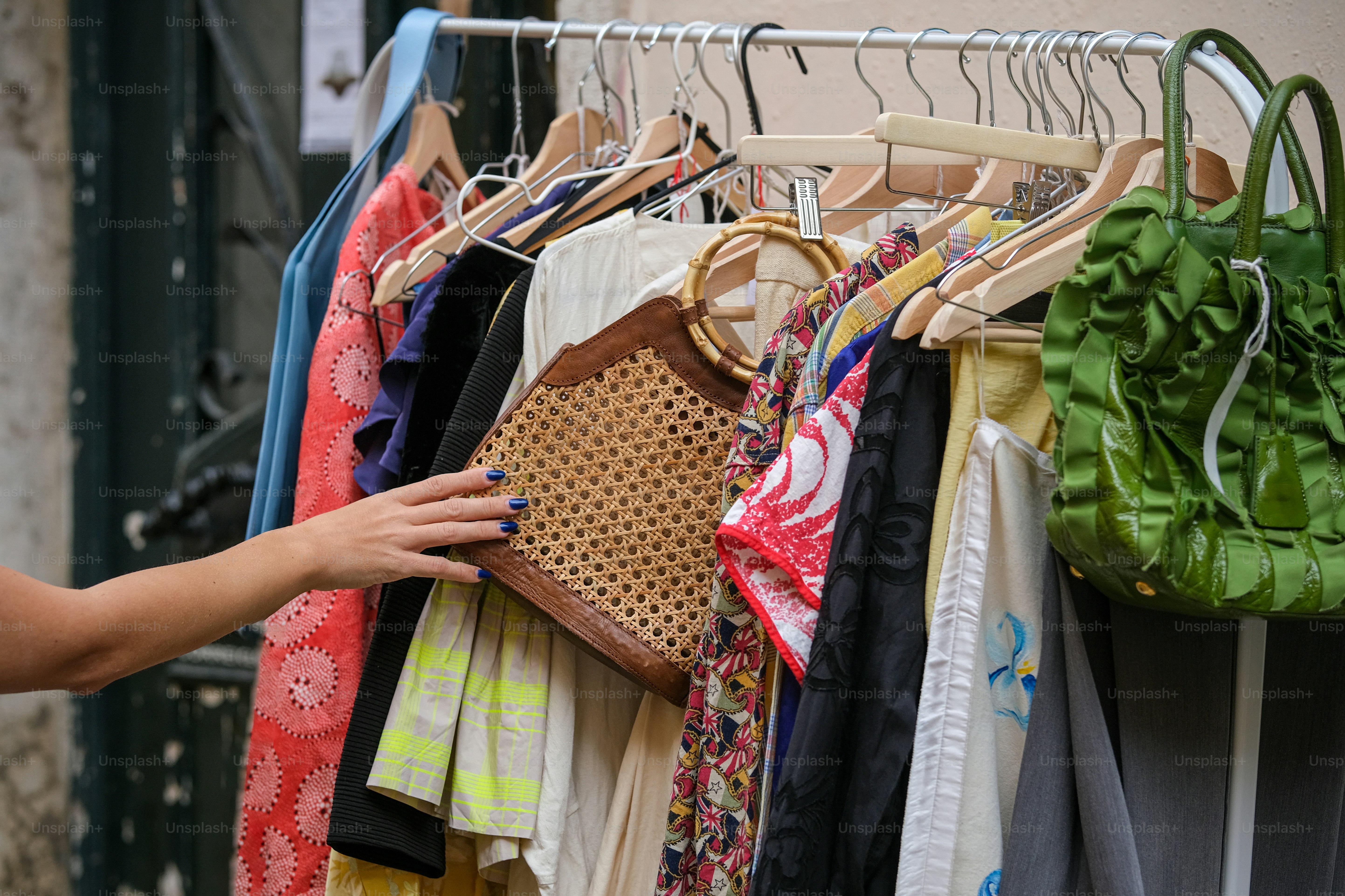 A woman looking at clothes hanging on a rack