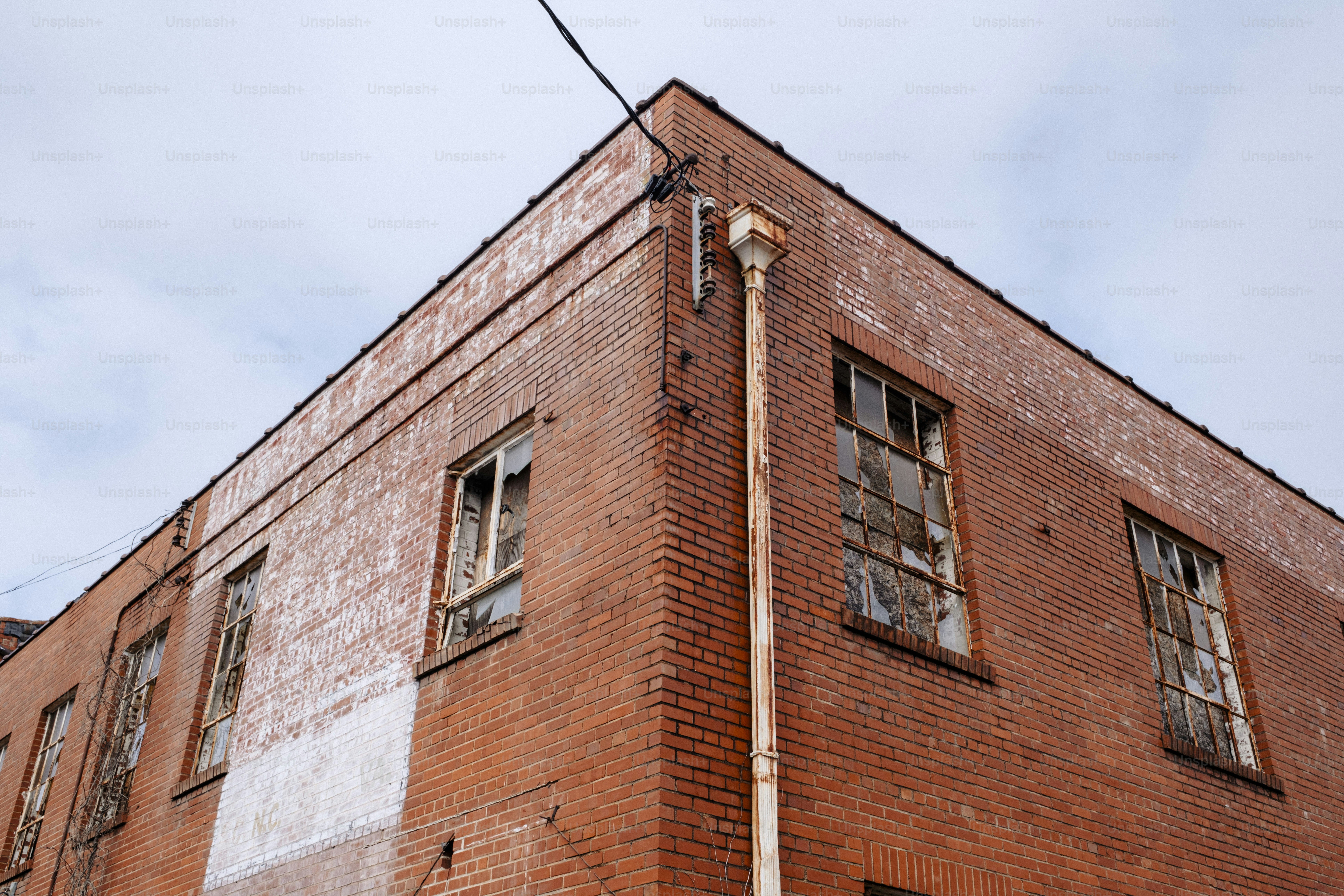 A tall brick building with windows on the top of it