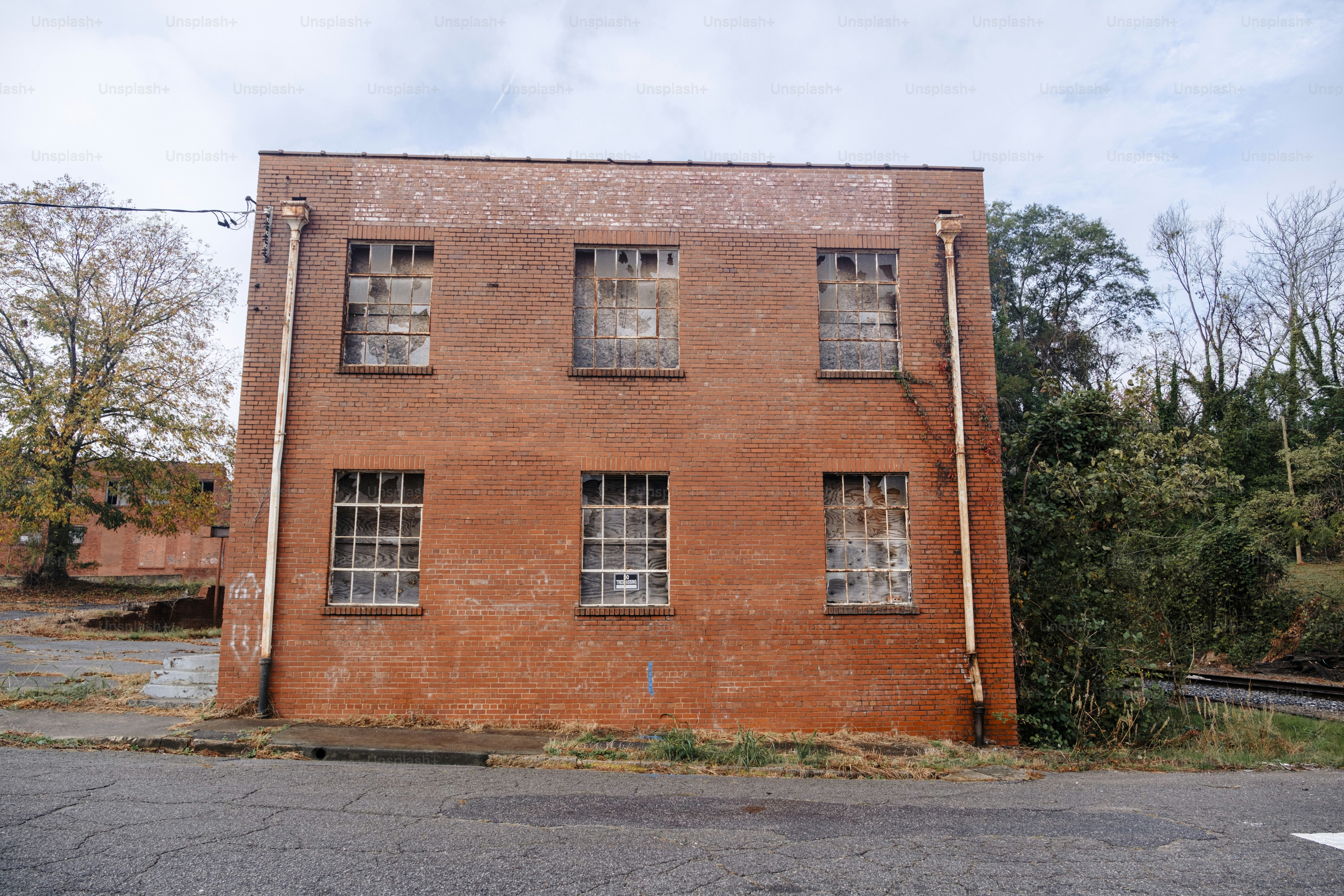 A red brick building sitting on the side of a road