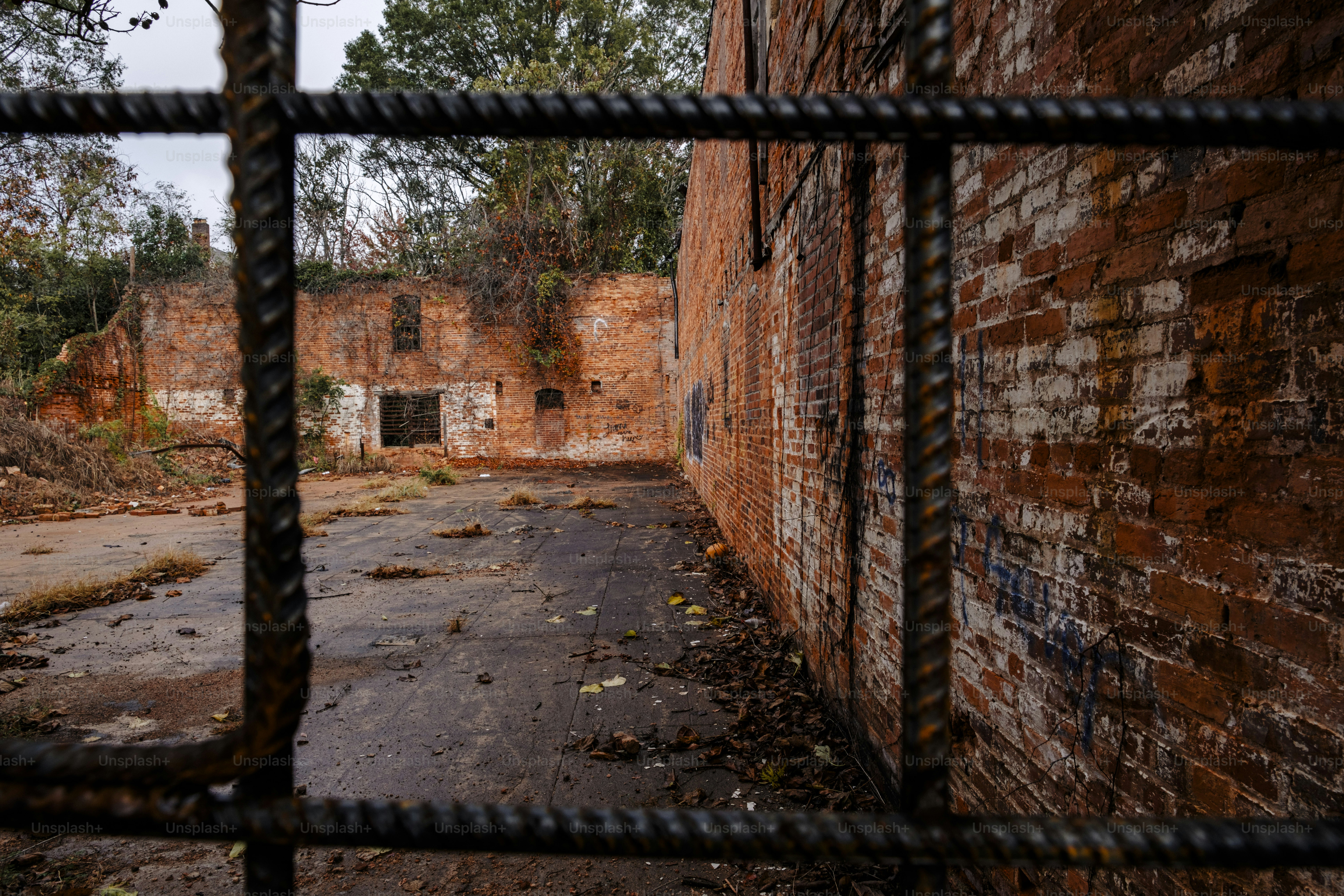 A brick building with a chain link fence in front of it