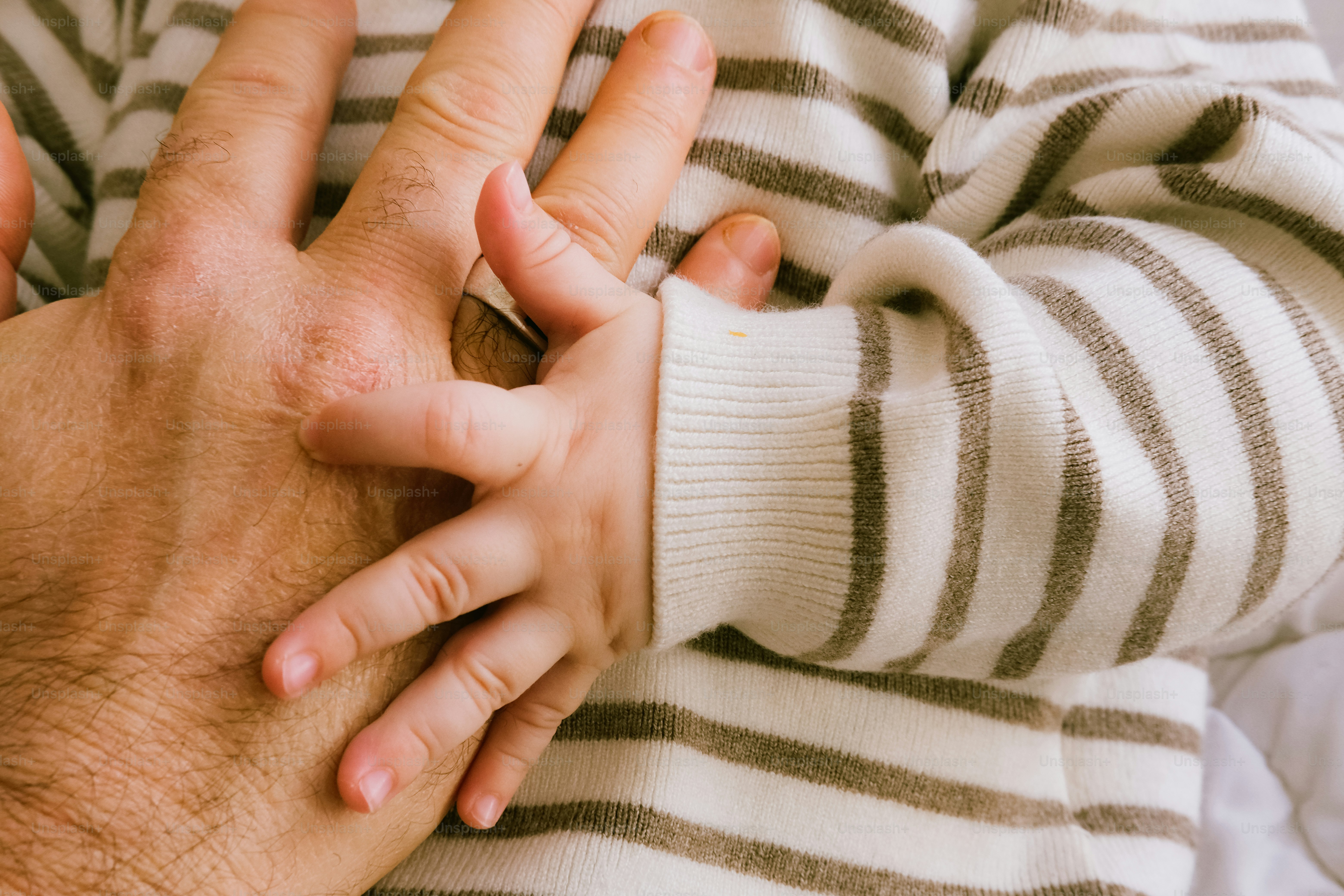 A close up of a person holding another person's hand