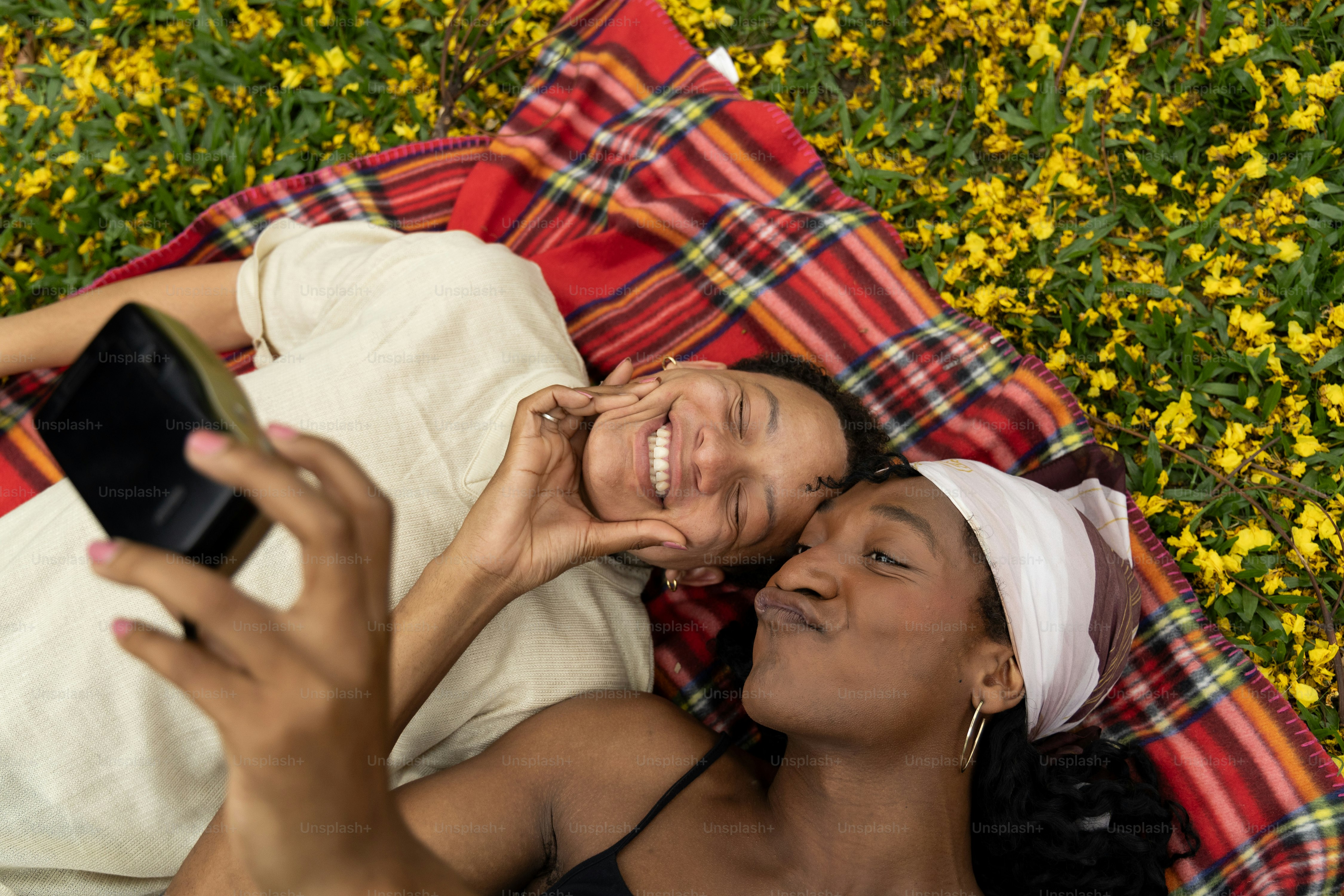 Una coppia di donne sdraiate sopra una coperta