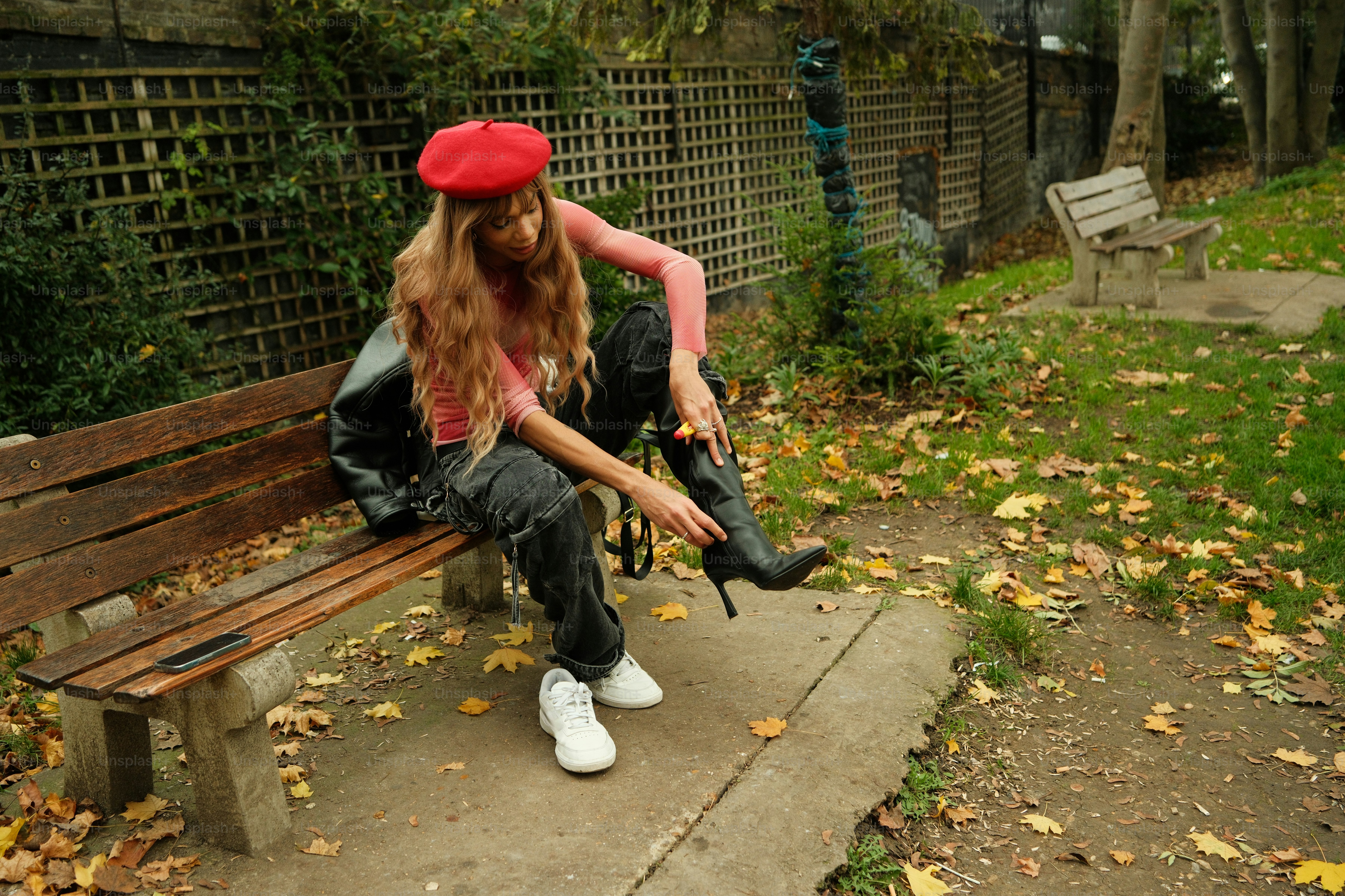 A woman sitting on a bench in a park