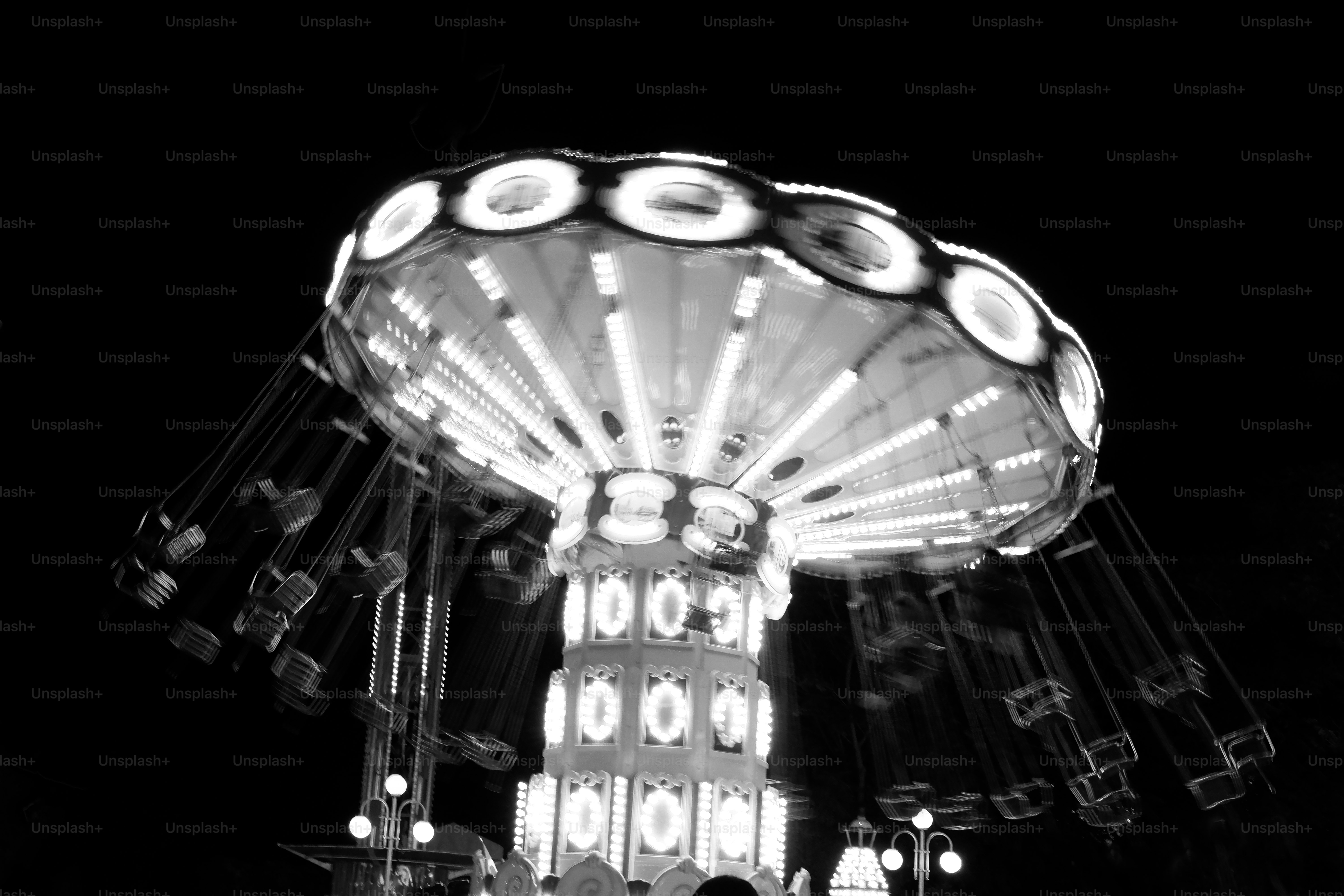 A black and white photo of a carnival ride