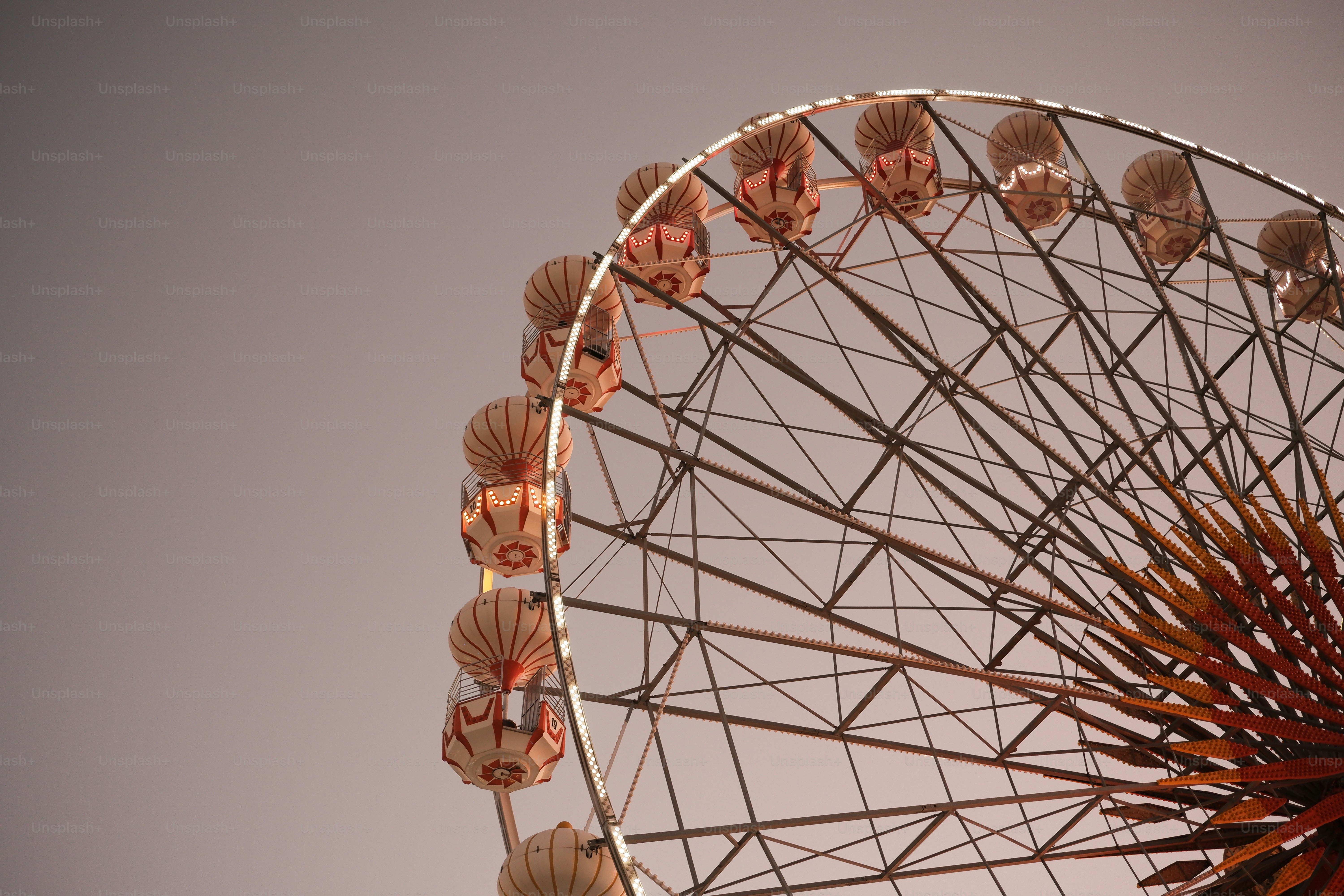 A close up of a ferris wheel on a cloudy day