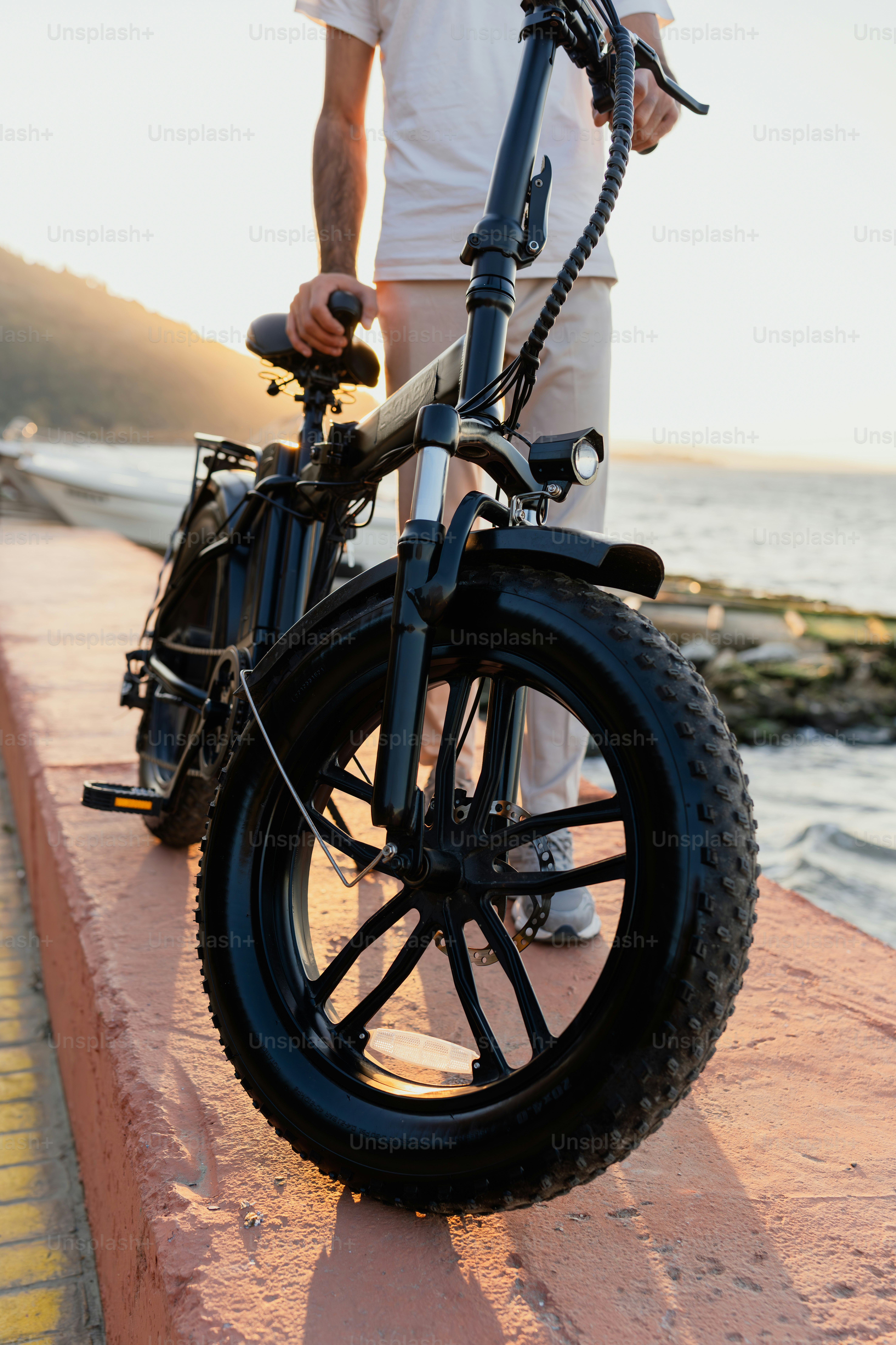 A man standing next to a parked bike