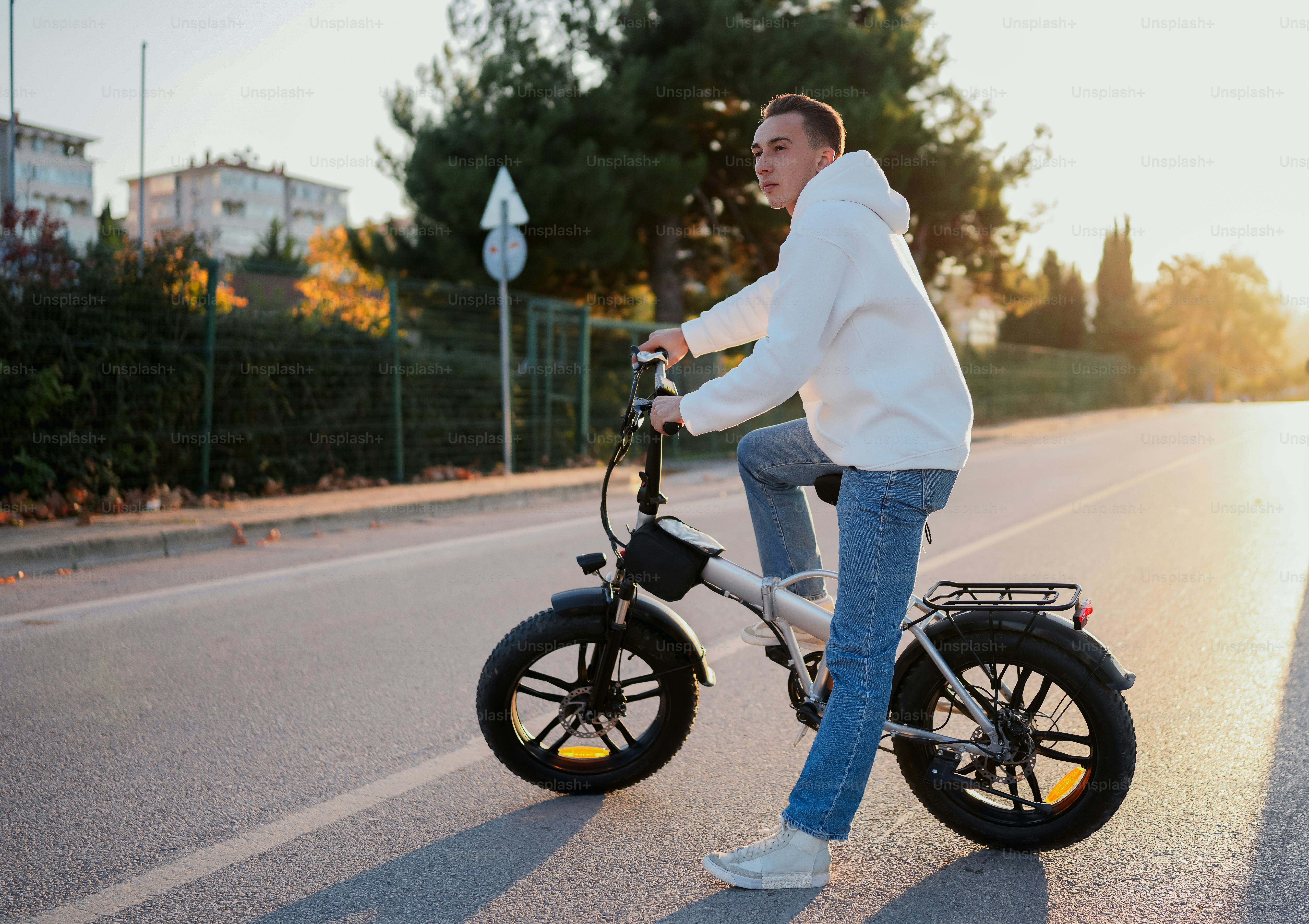 A man riding a bike down a street