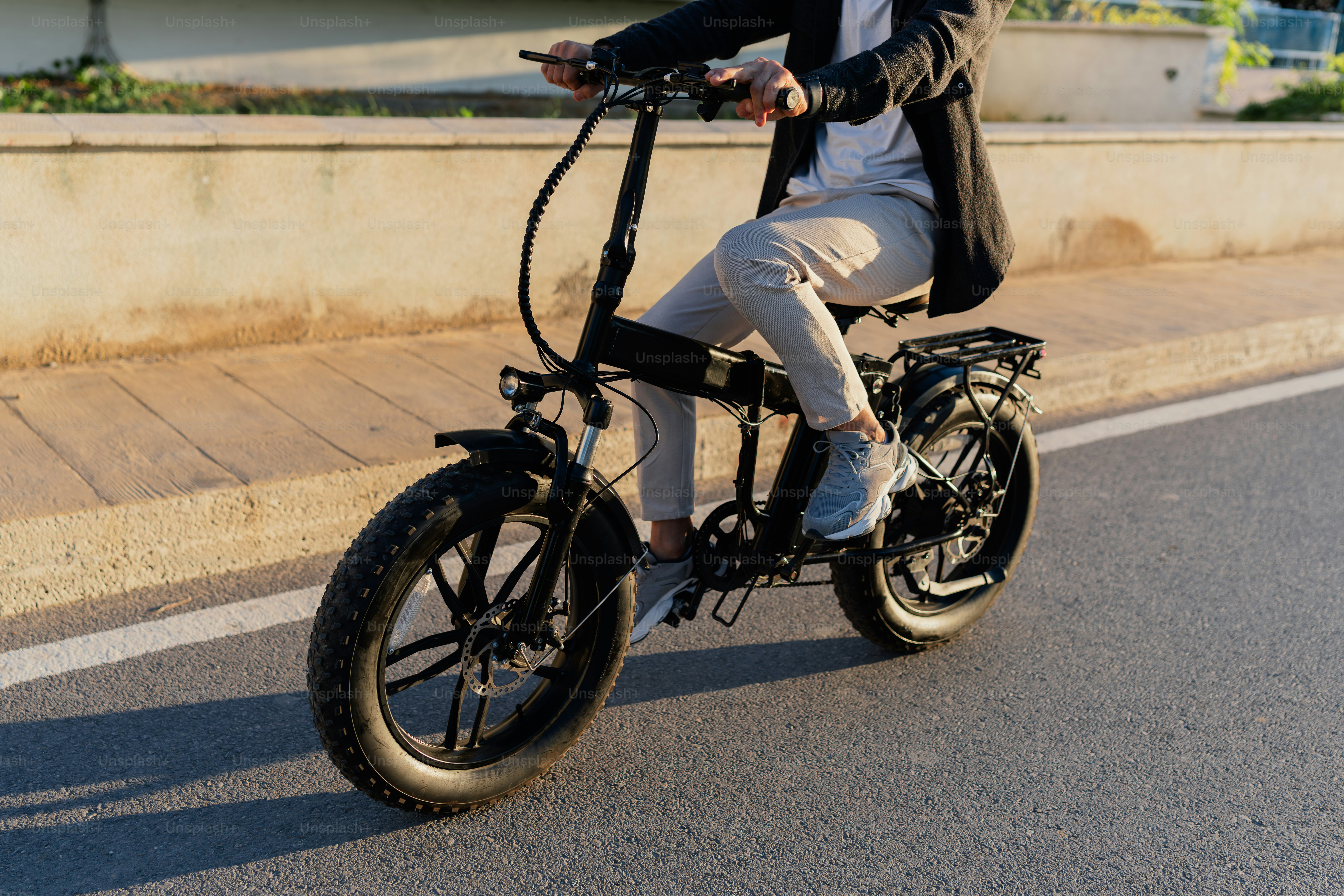 A man riding a bike down a street