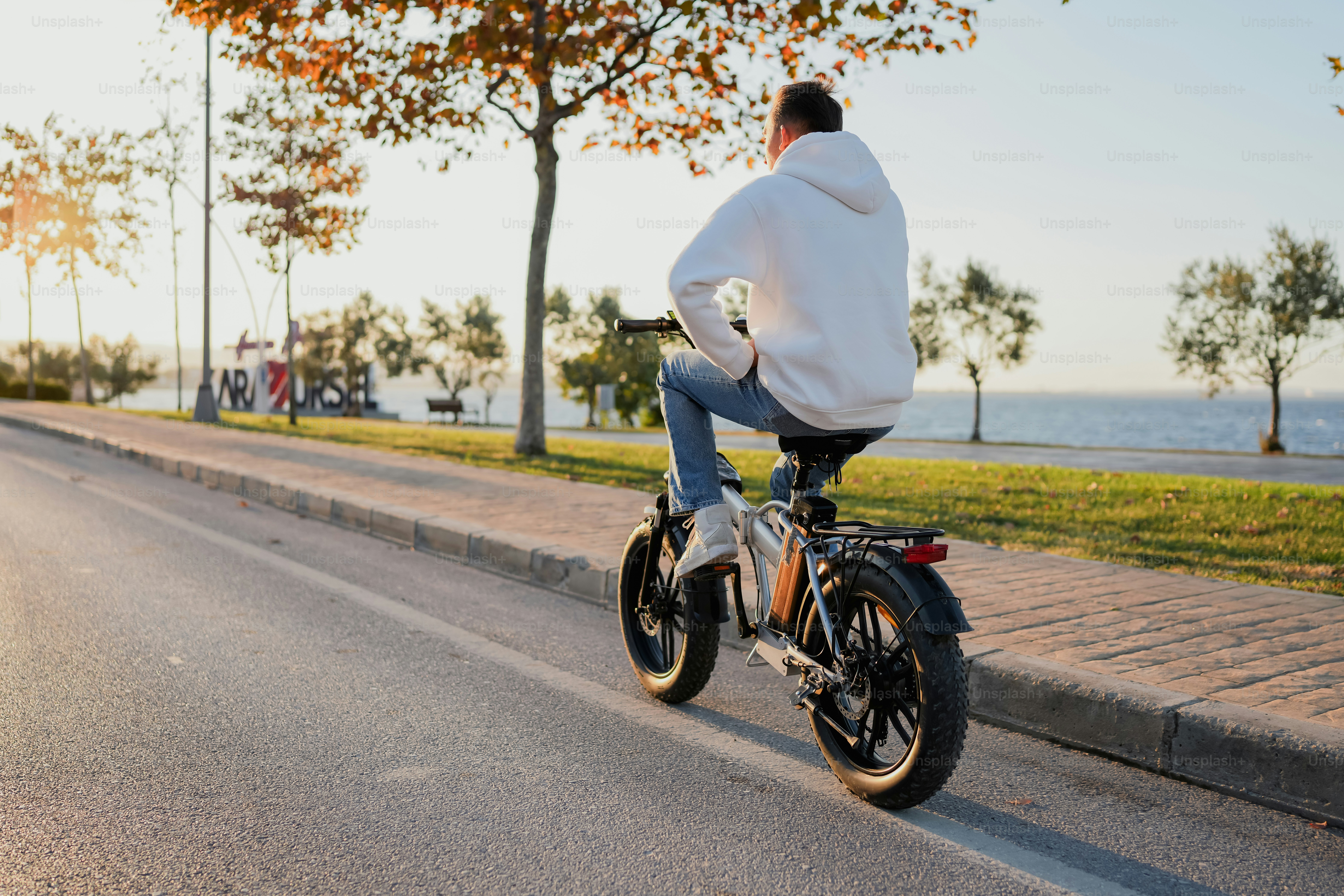 A man riding a motorcycle down a street