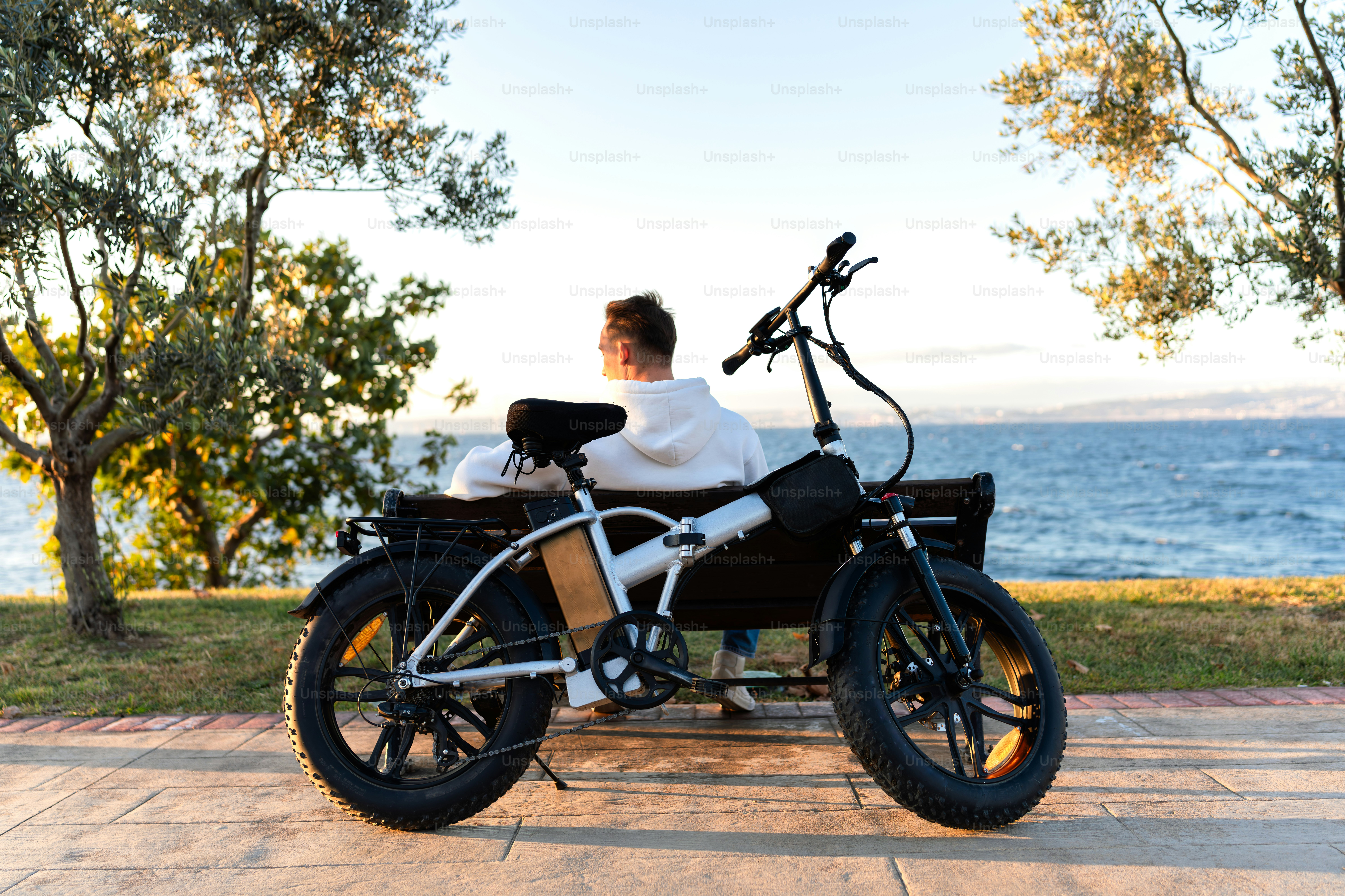 A man sitting on a bike with a laptop