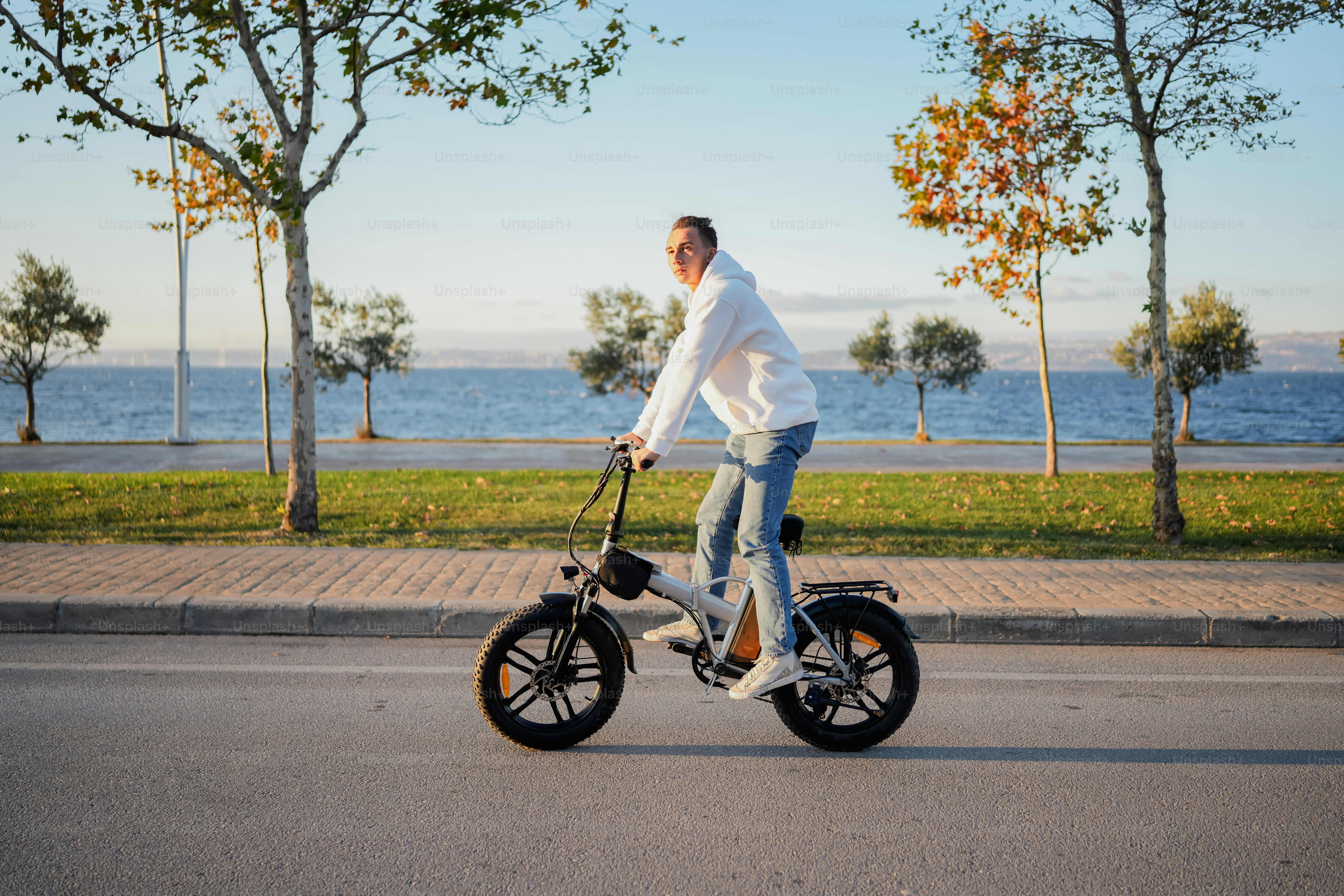A man riding an electric scooter down a street