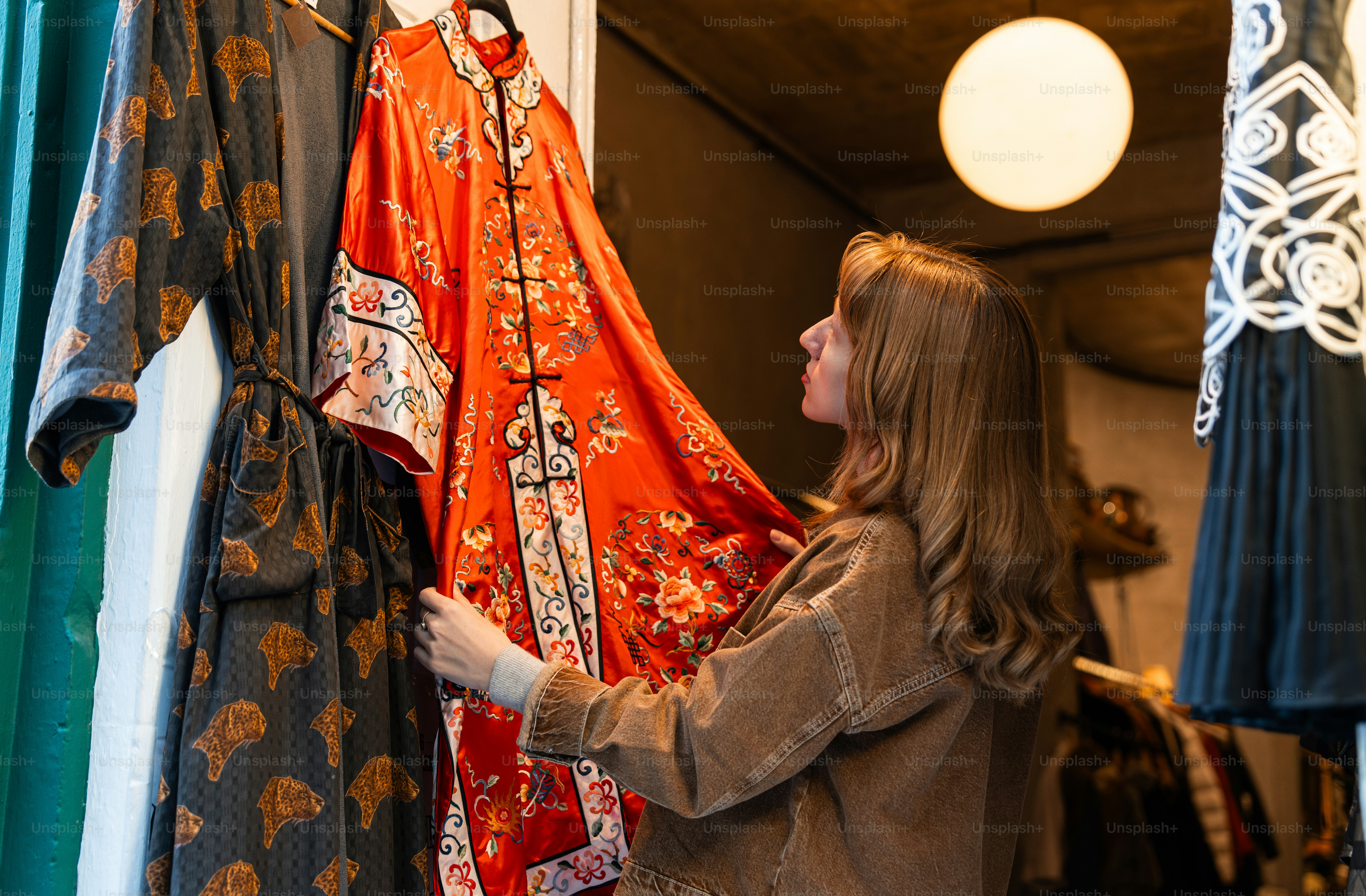 A woman looking at clothes hanging on a rack