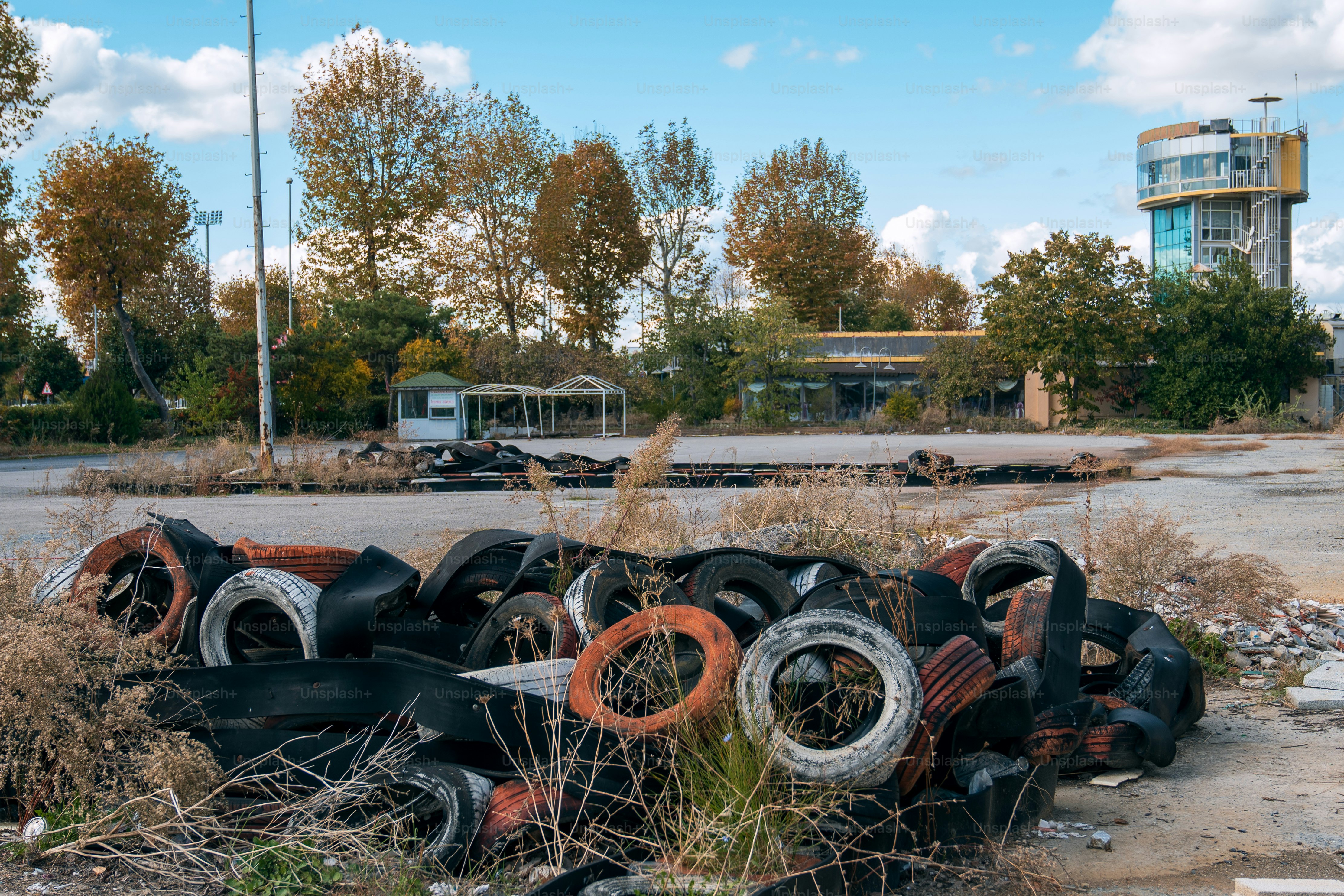 A pile of tires sitting in the middle of a parking lot