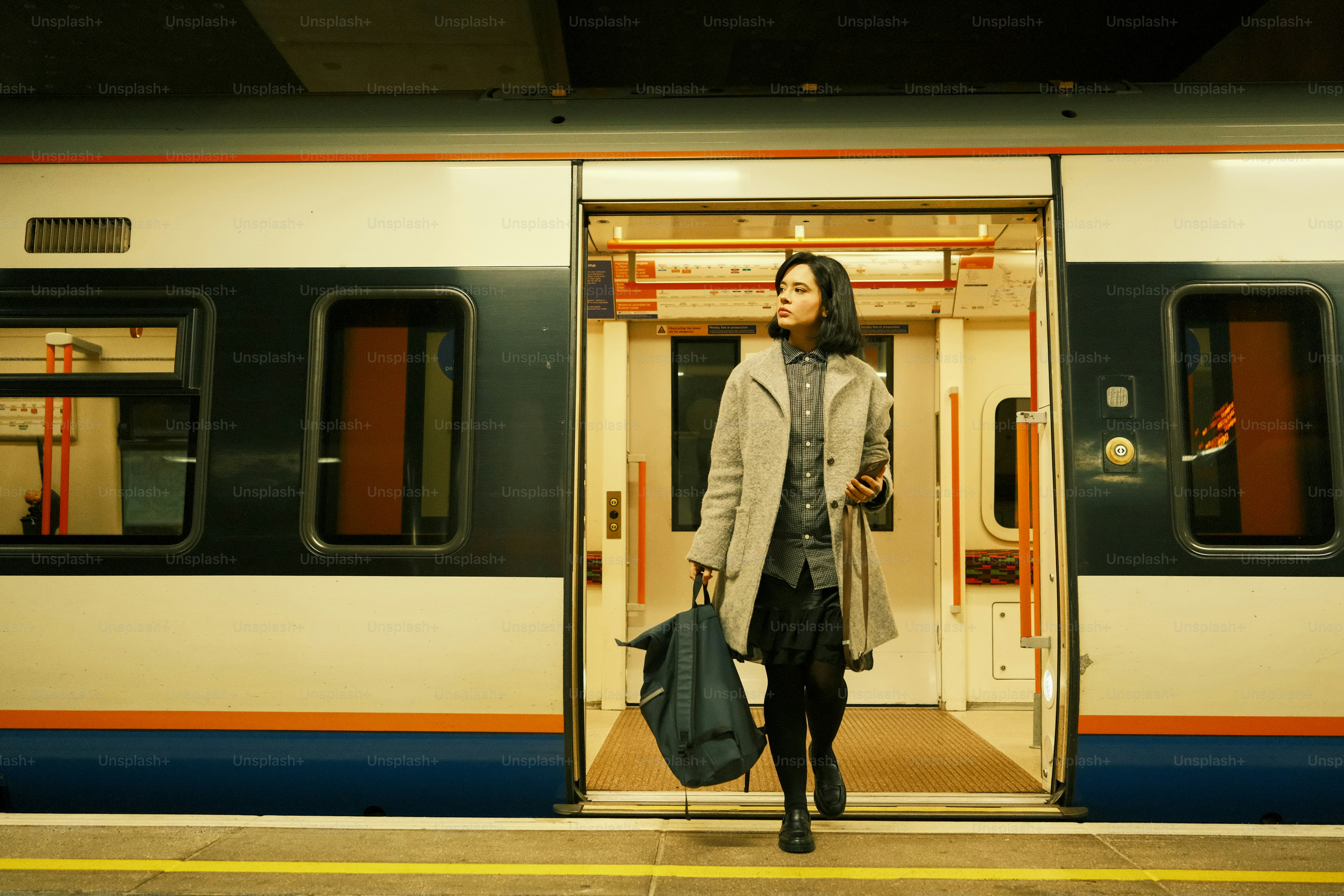 A woman is standing in the doorway of a train