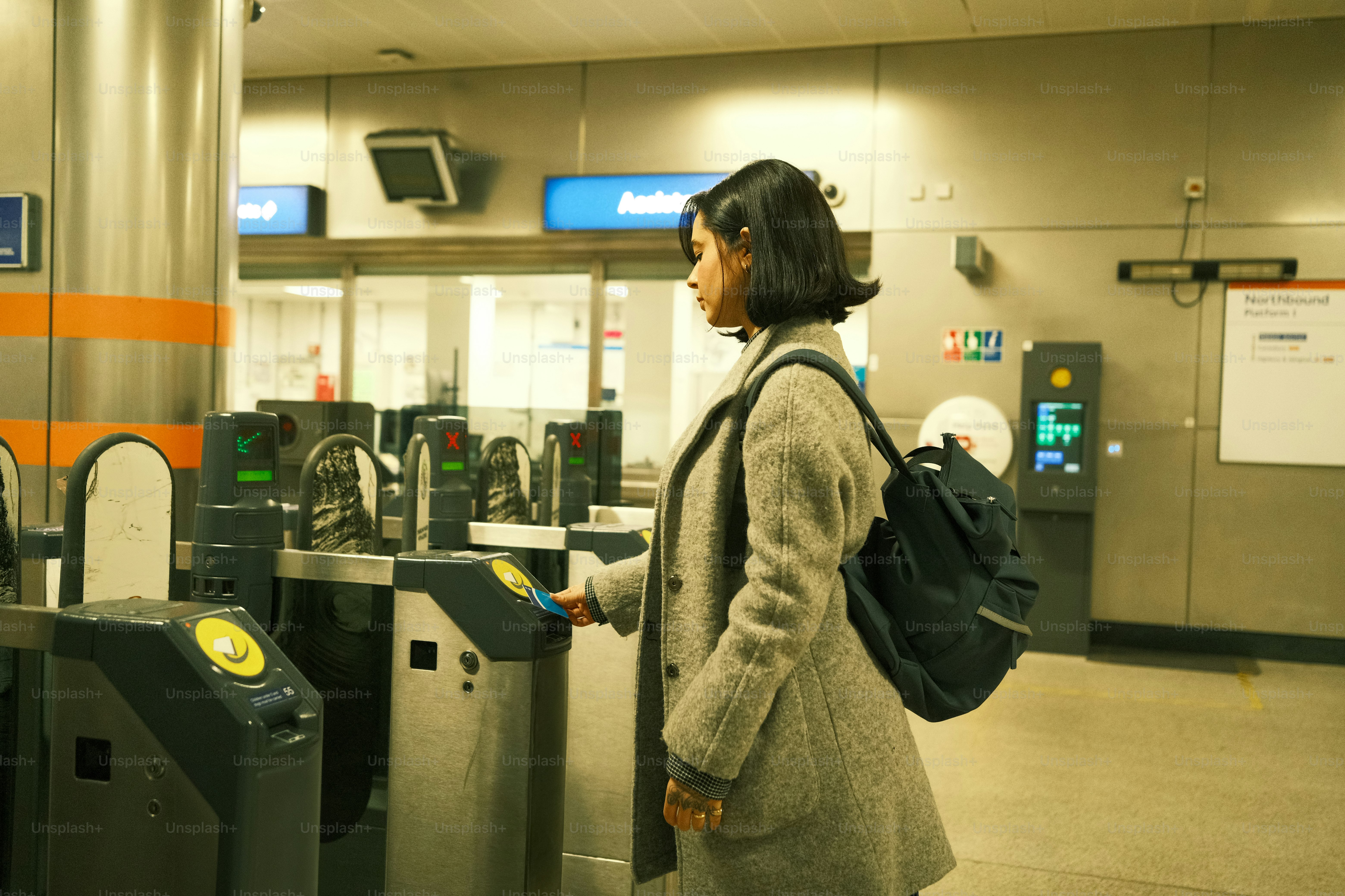 A woman with a backpack standing in front of a check in counter
