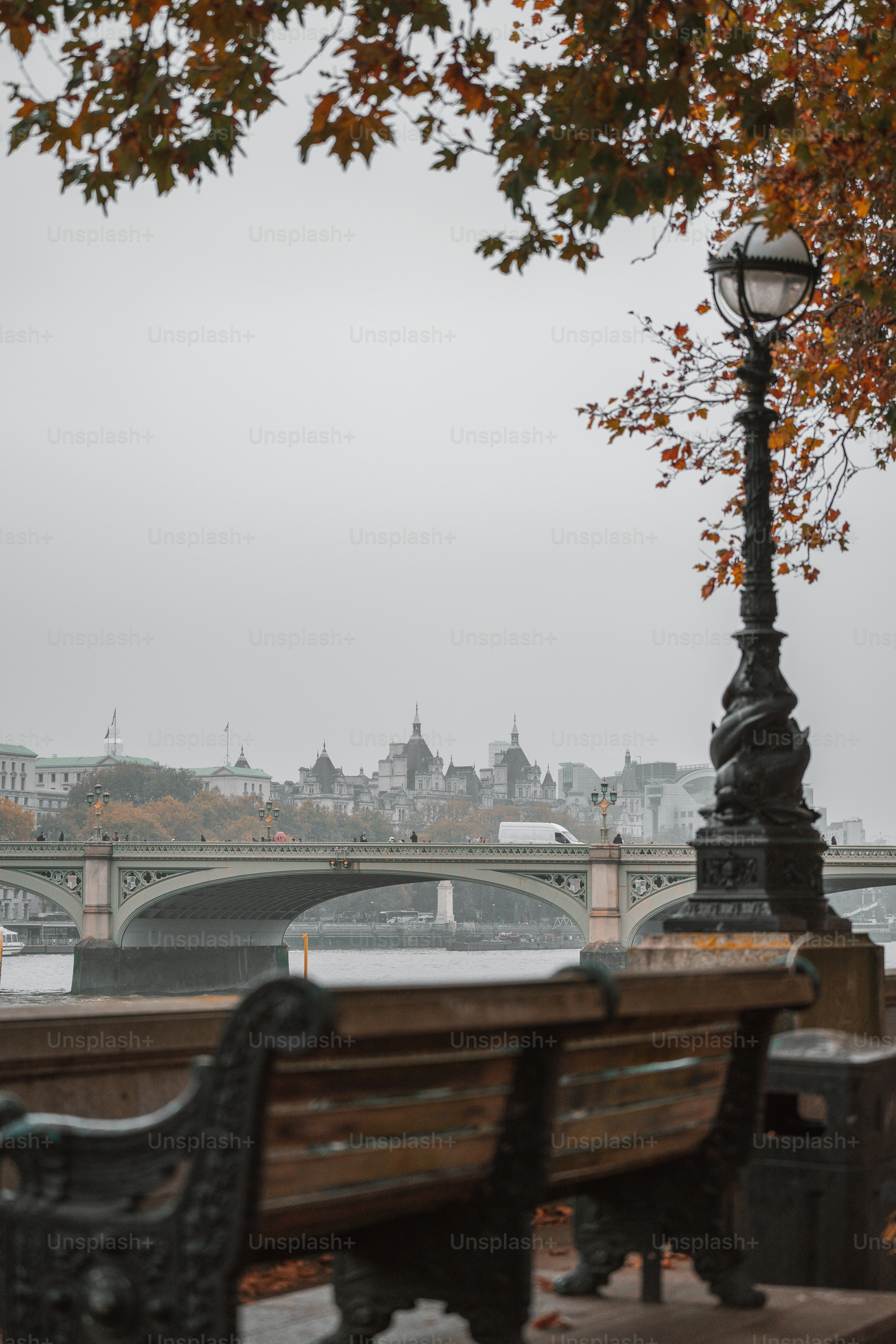 A wooden bench sitting next to a lamp post