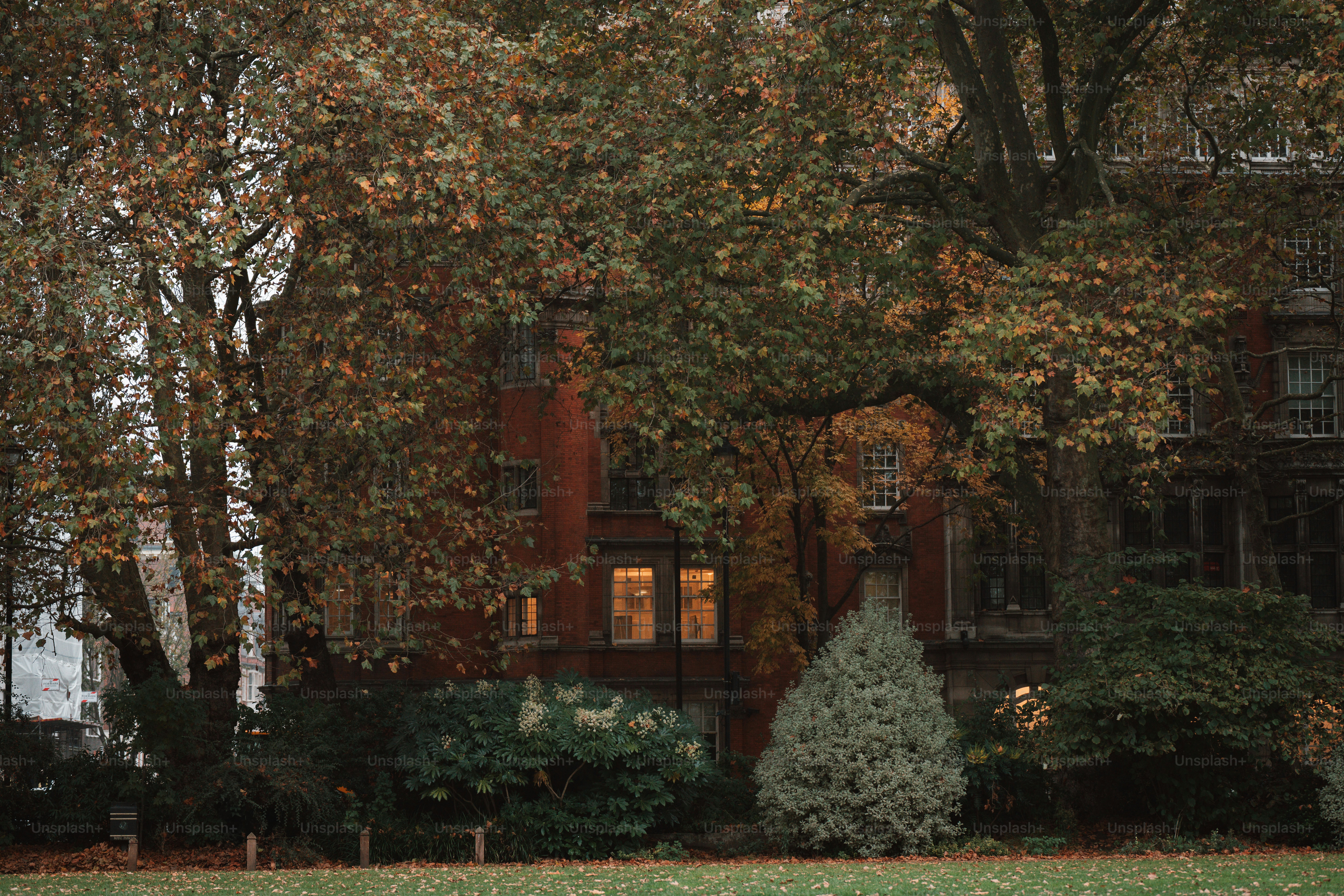 A large house with a clock tower in front of it