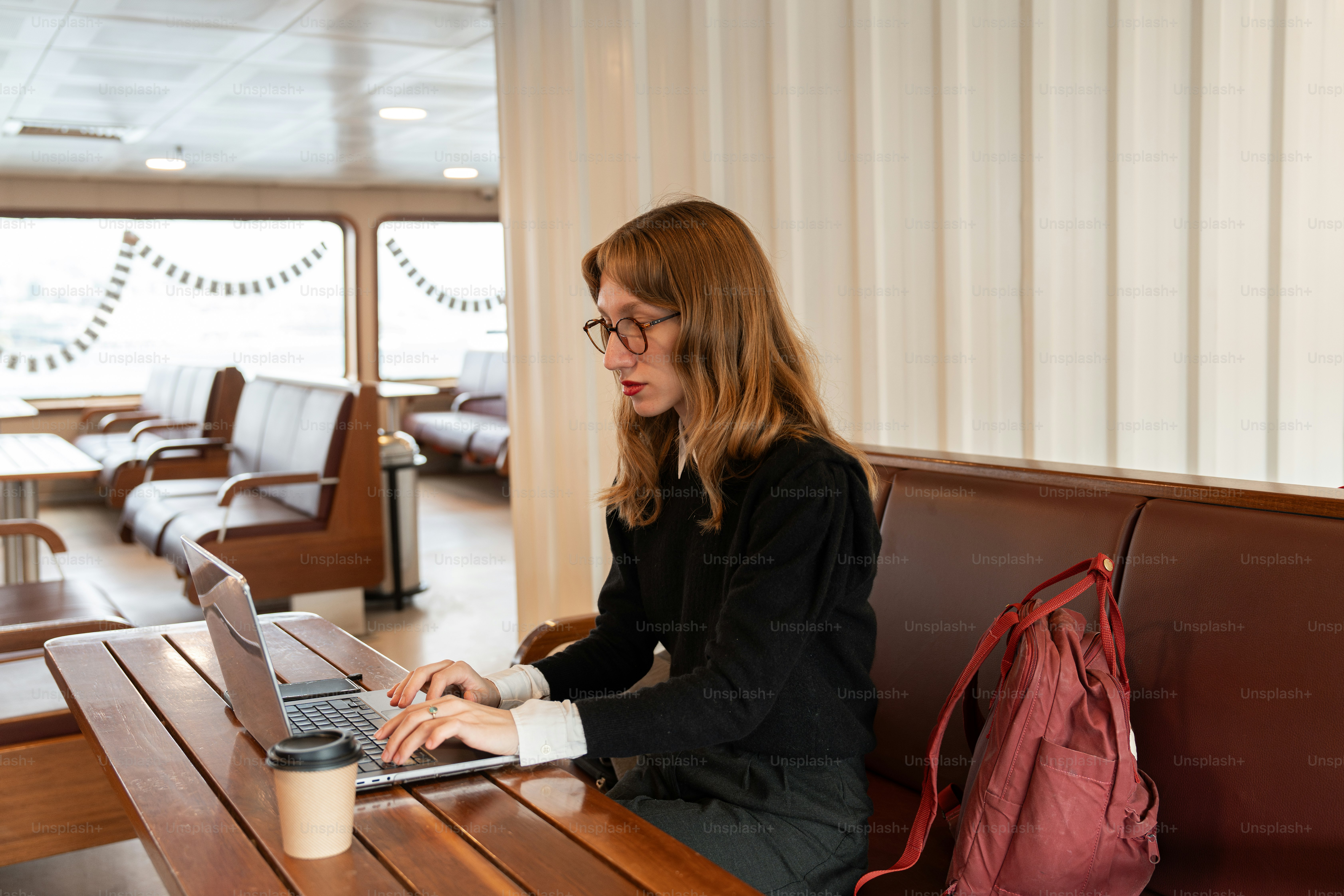 A woman sitting at a table with a laptop