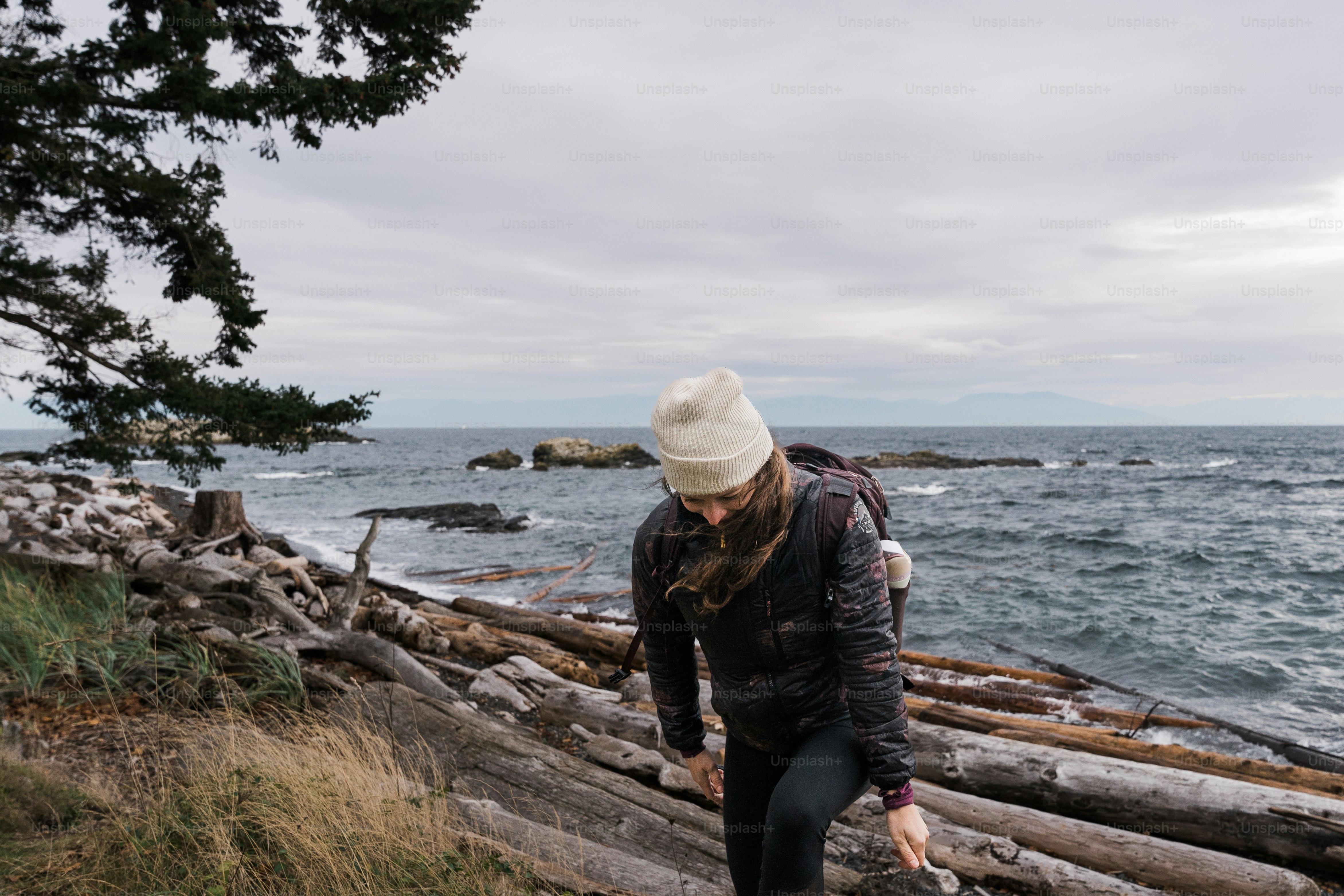 A man walking along a beach next to the ocean