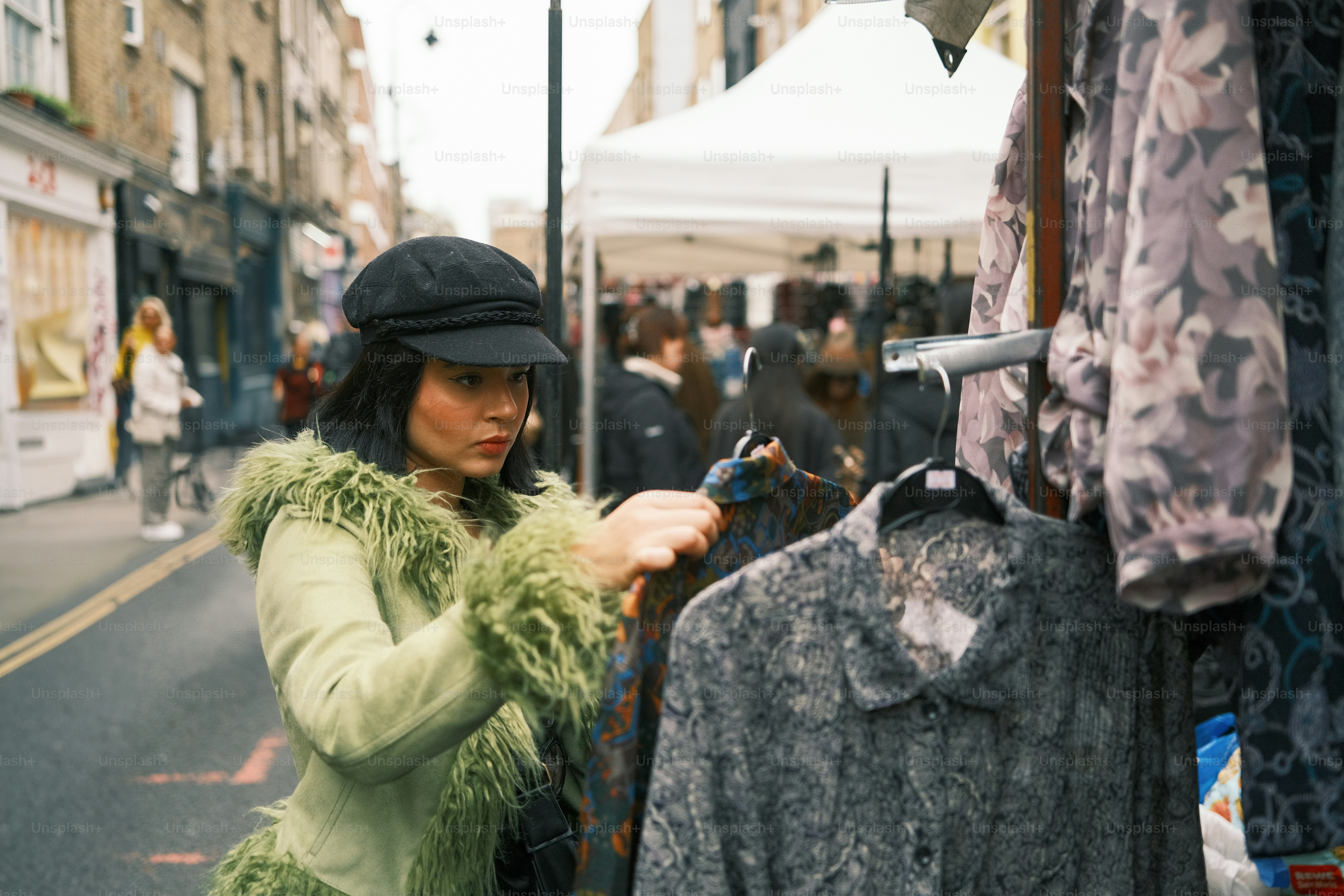 A woman in a green coat looking at a shirt