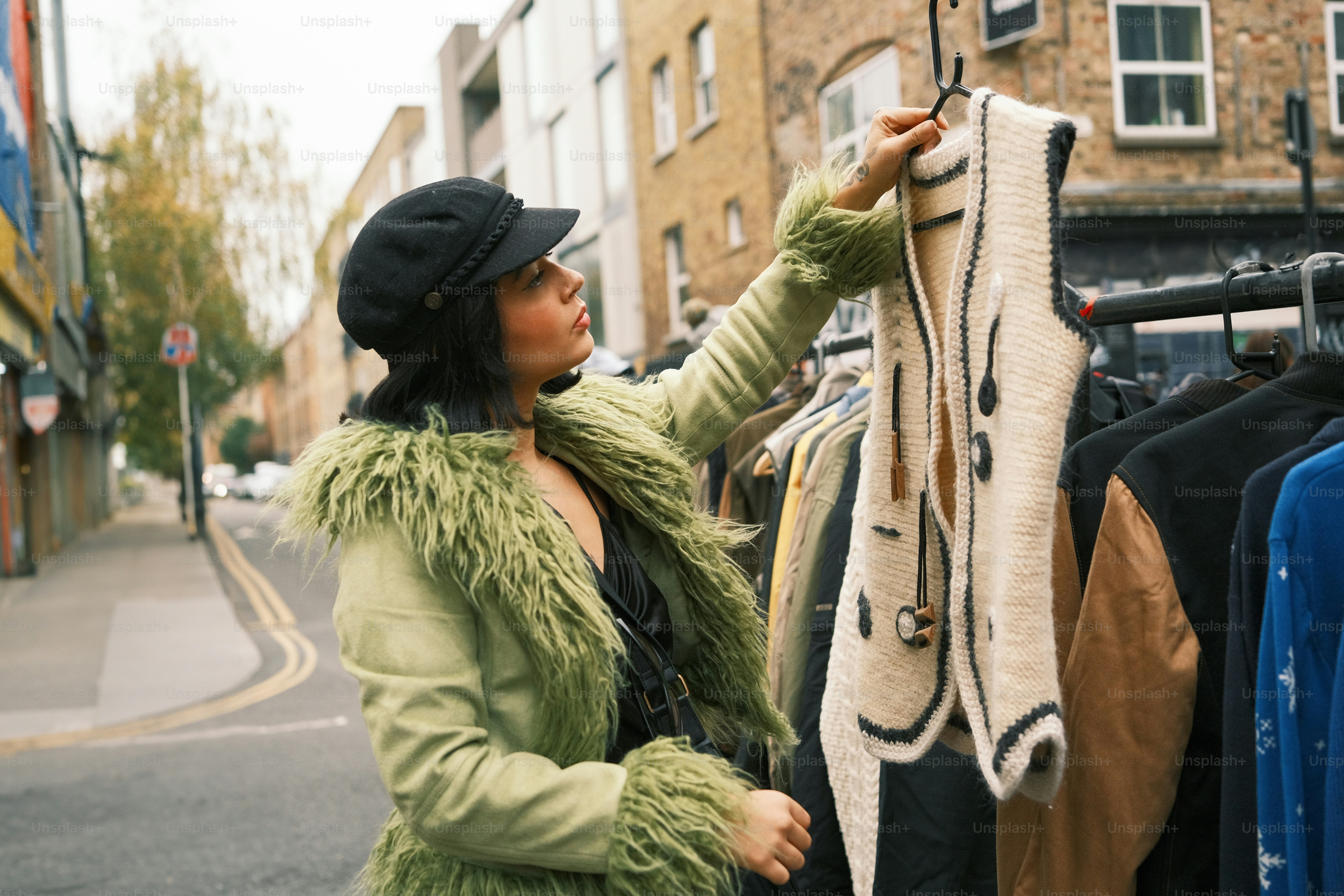 A woman looking at clothes hanging on a rack