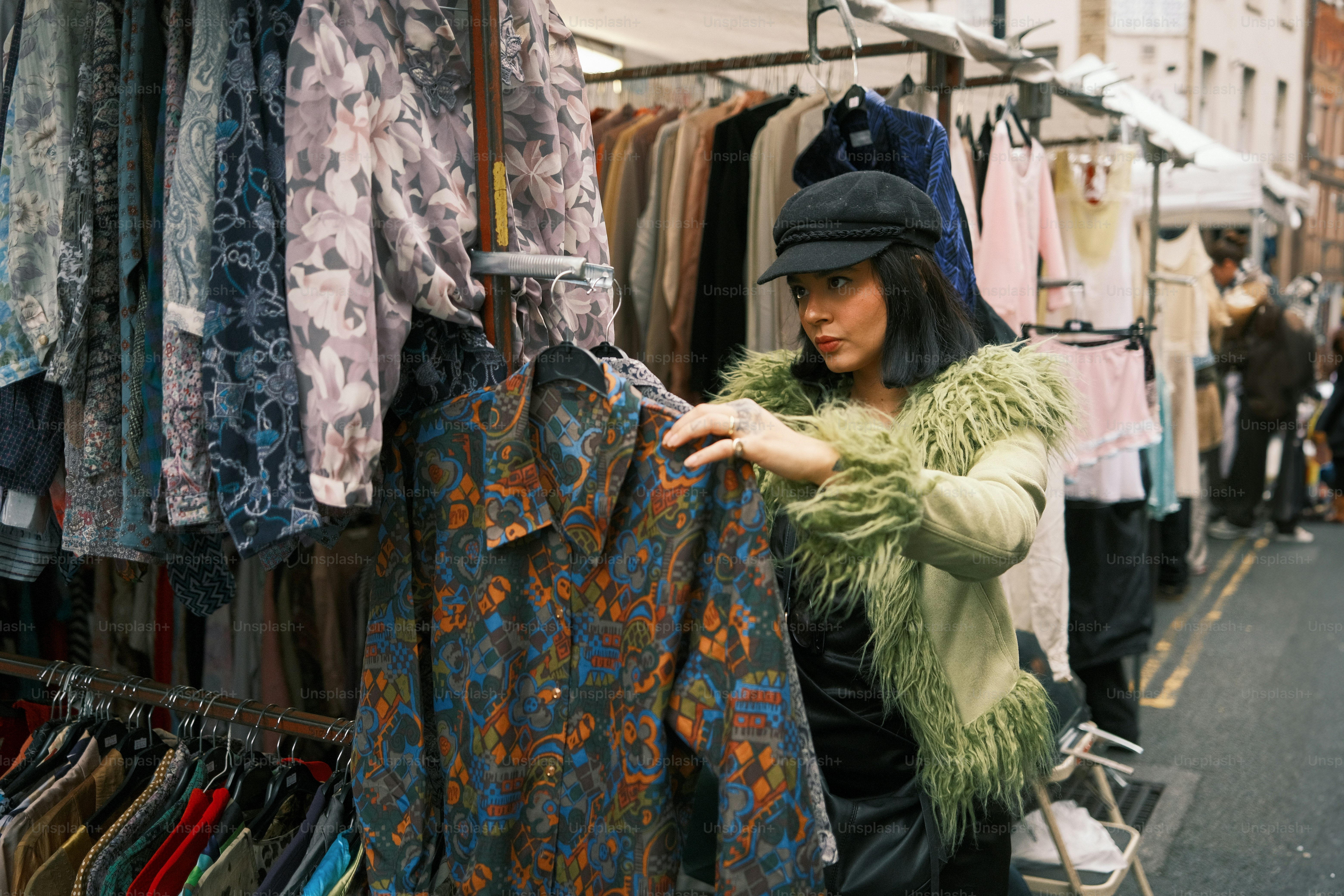 A woman is looking at clothes on a rack