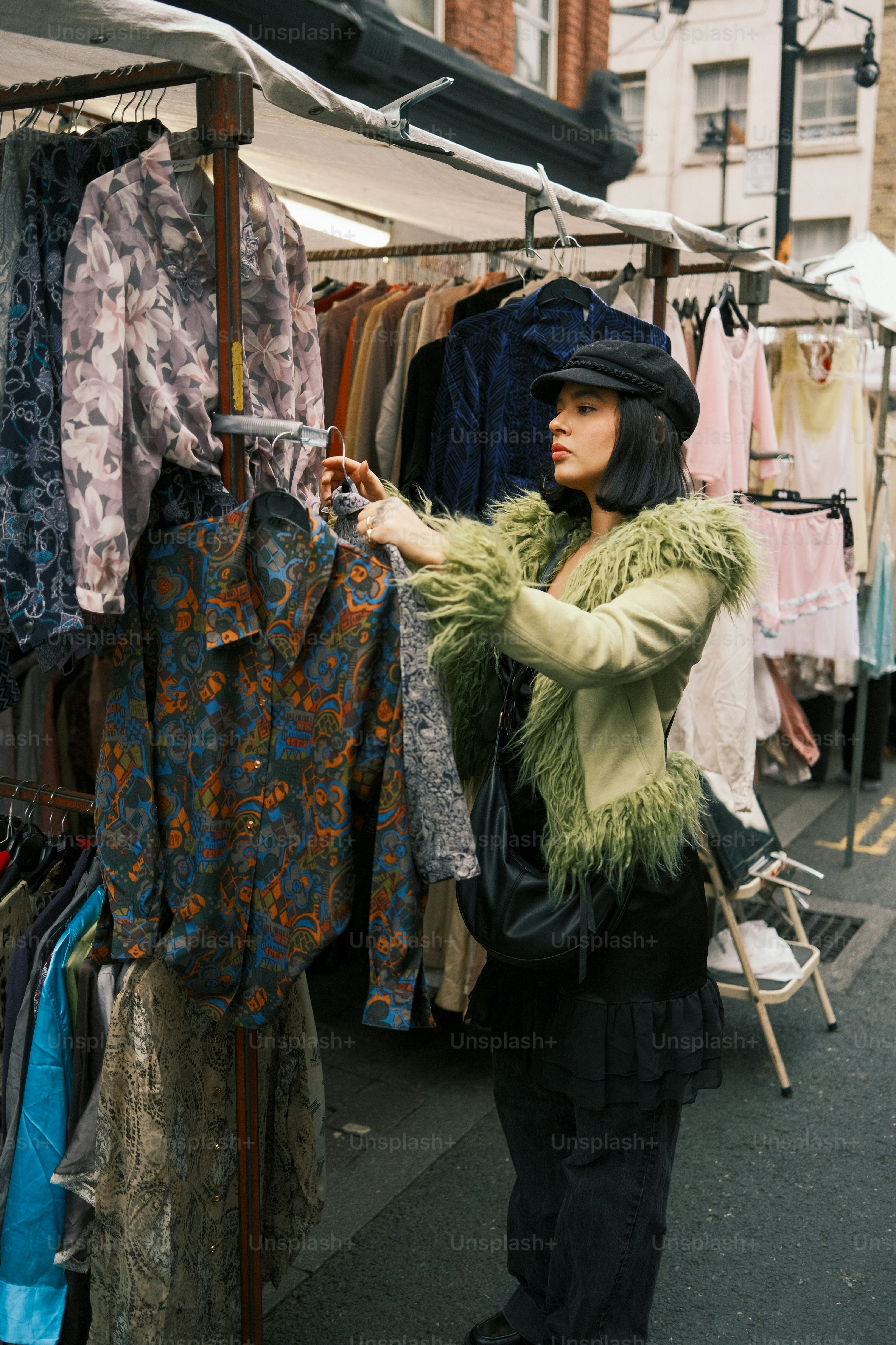 A woman is looking at clothes on a rack