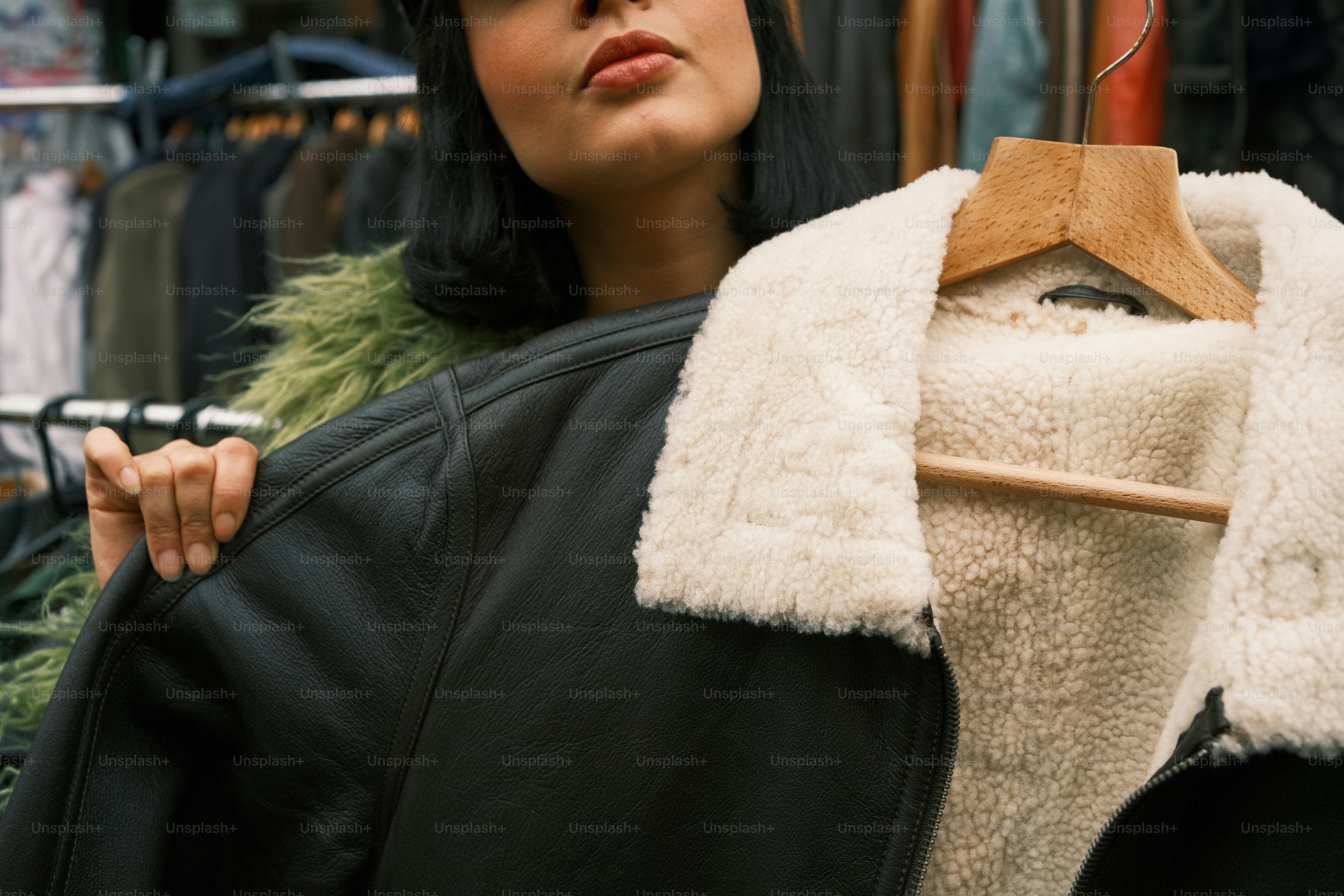 A woman standing in front of a rack of clothes
