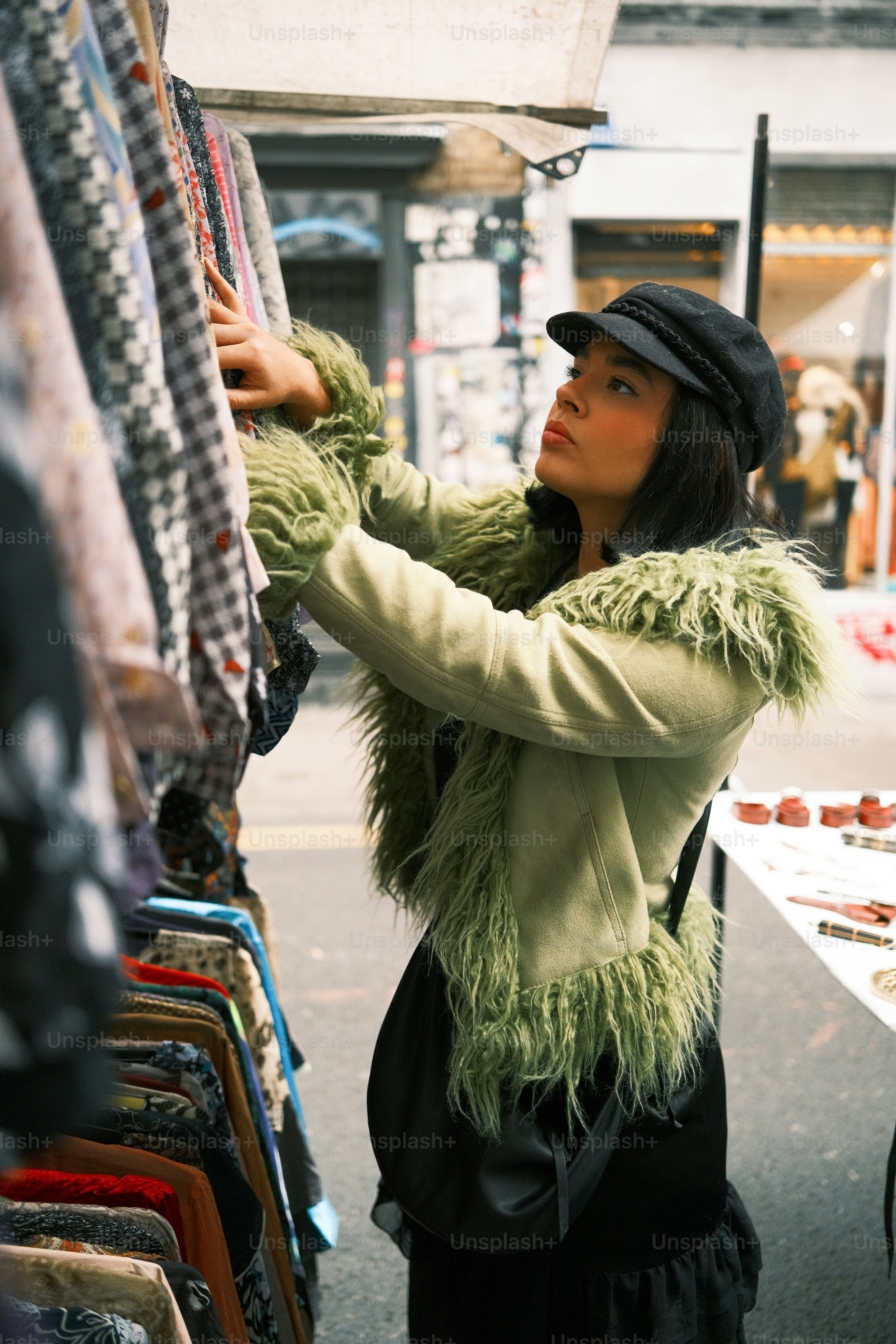 A woman looking at a rack of clothes