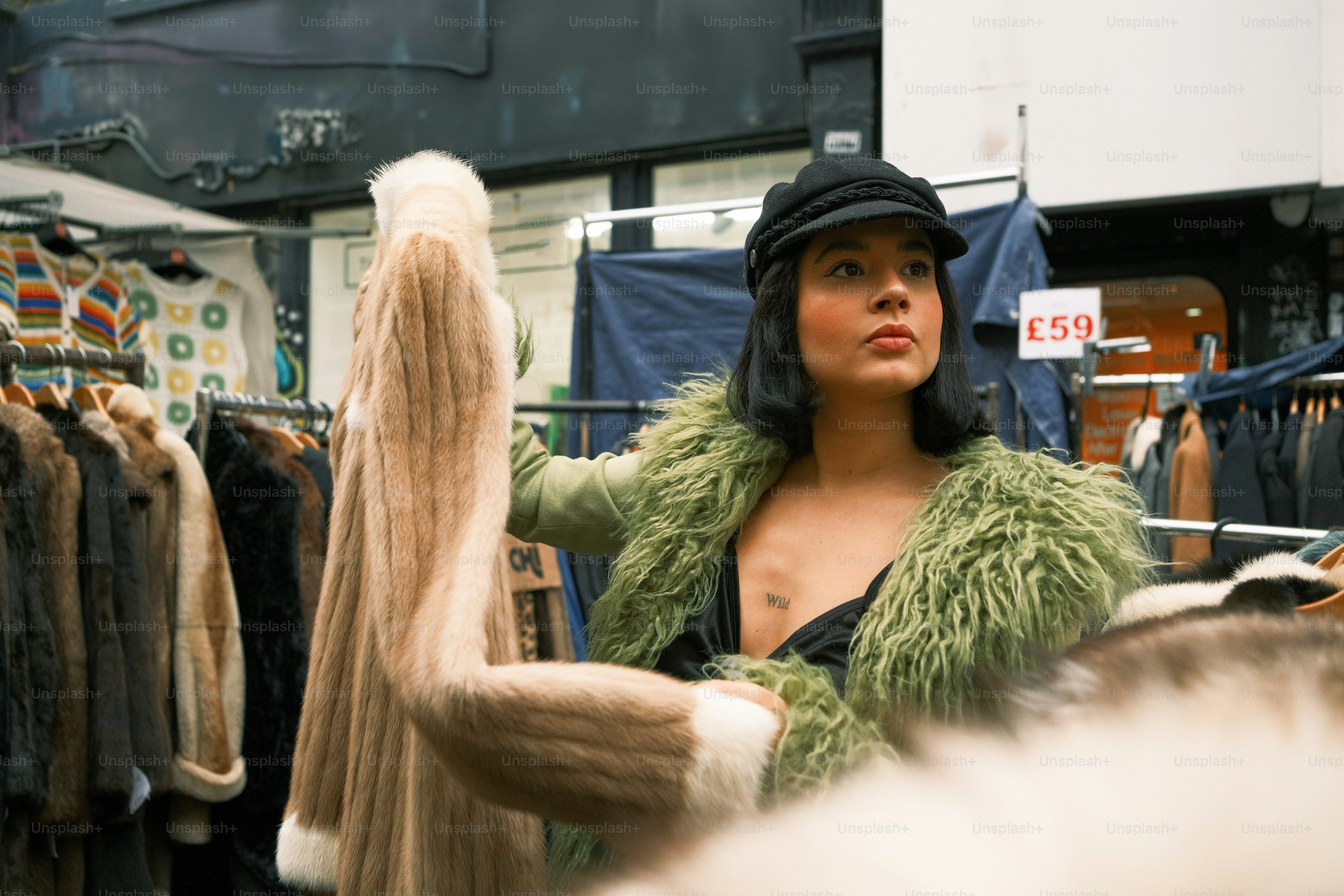 A woman standing in front of a rack of clothes
