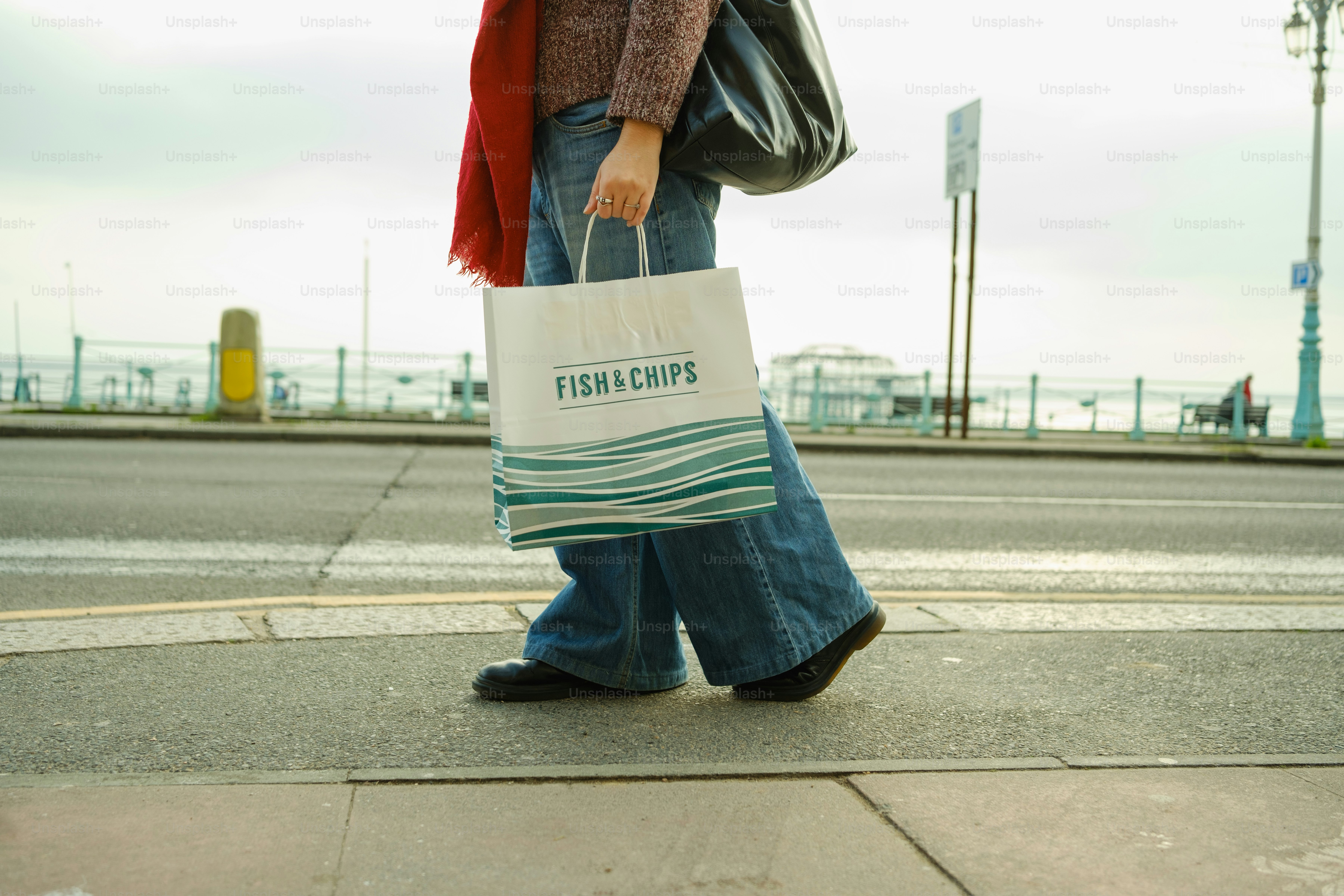 A woman walking down the street with a shopping bag